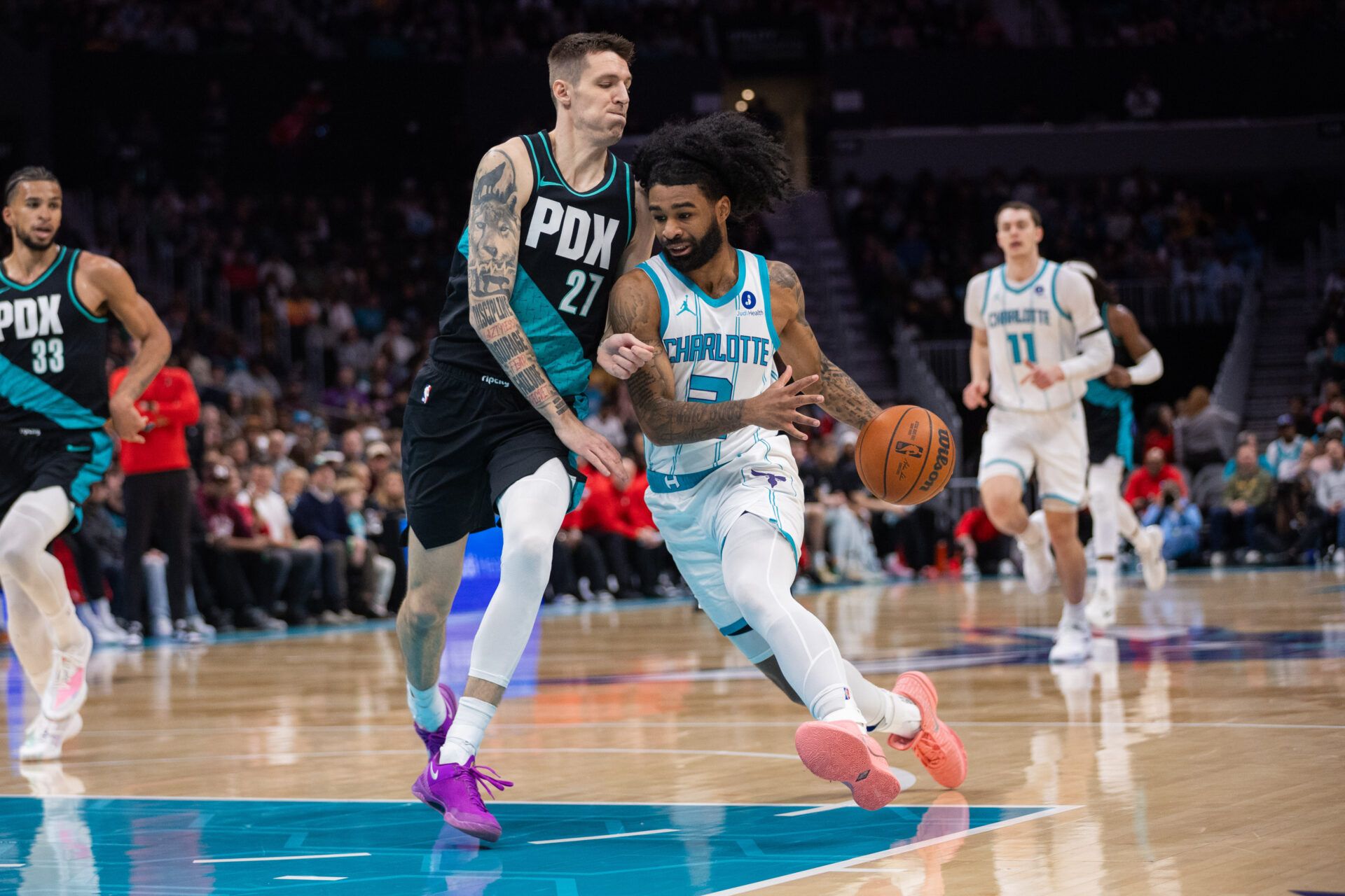 Charlotte Hornets guard Coby White (3) drives to the basket against Portland Trail Blazers guard Vit Krejci (27) during the first quarter at Spectrum Center.