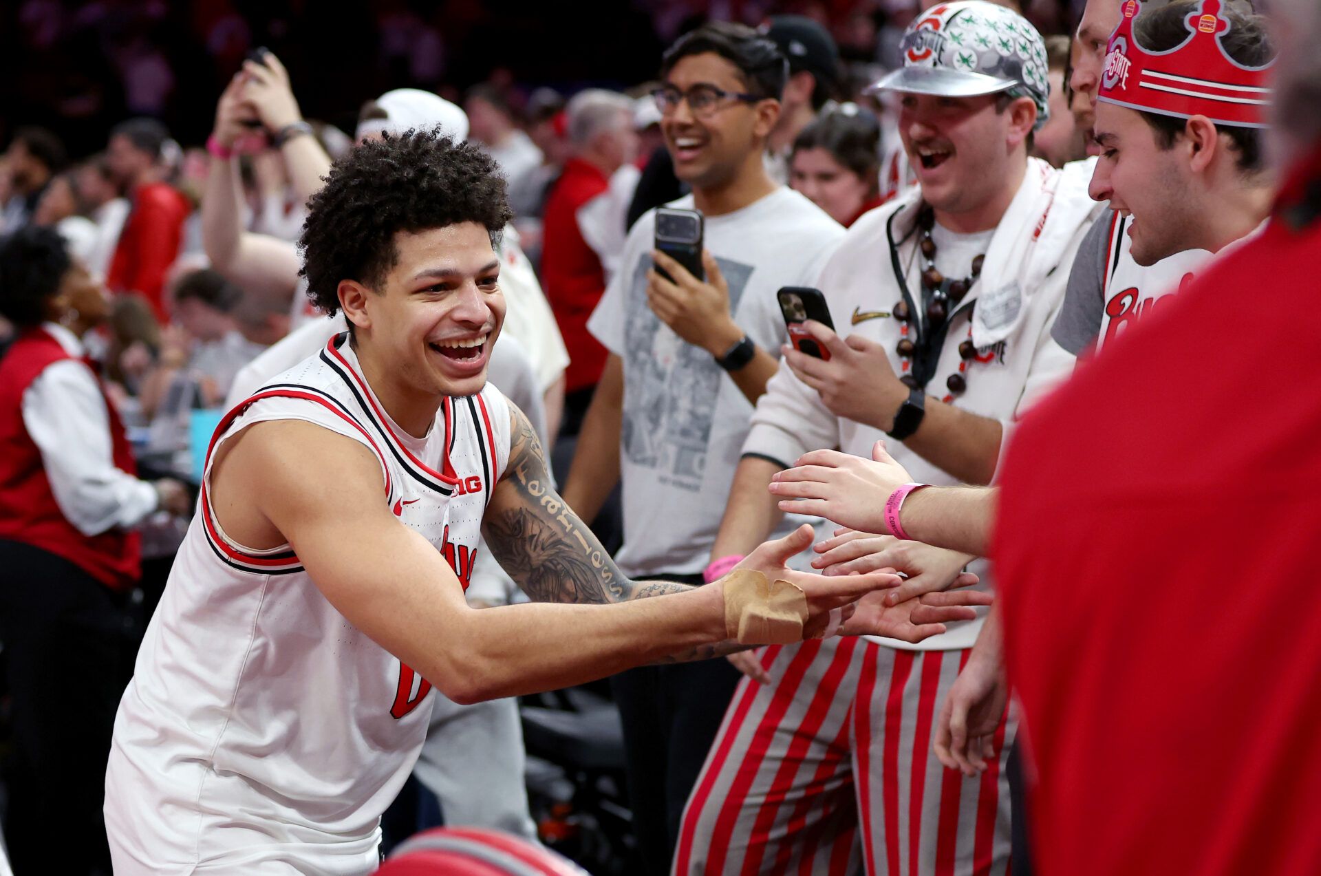 Ohio State Buckeyes guard John Mobley Jr. (0) celebrates with fans after the game against the Purdue Boilermakers at Value City Arena.