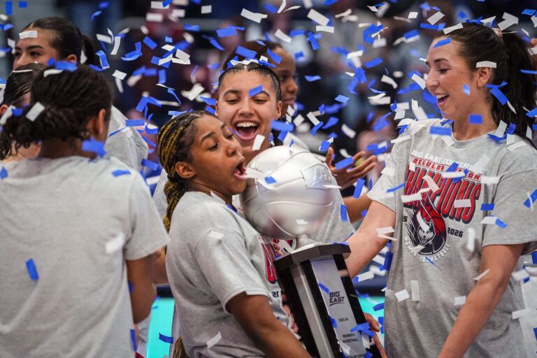 UConn Huskies guard Azzi Fudd (35), guard Kelis Fisher (7), guard Caroline Ducharme (33) and teammates celebrate their Big East Regular Season Title after defeating the Georgetown Hoyas at PeoplesBank Arena.