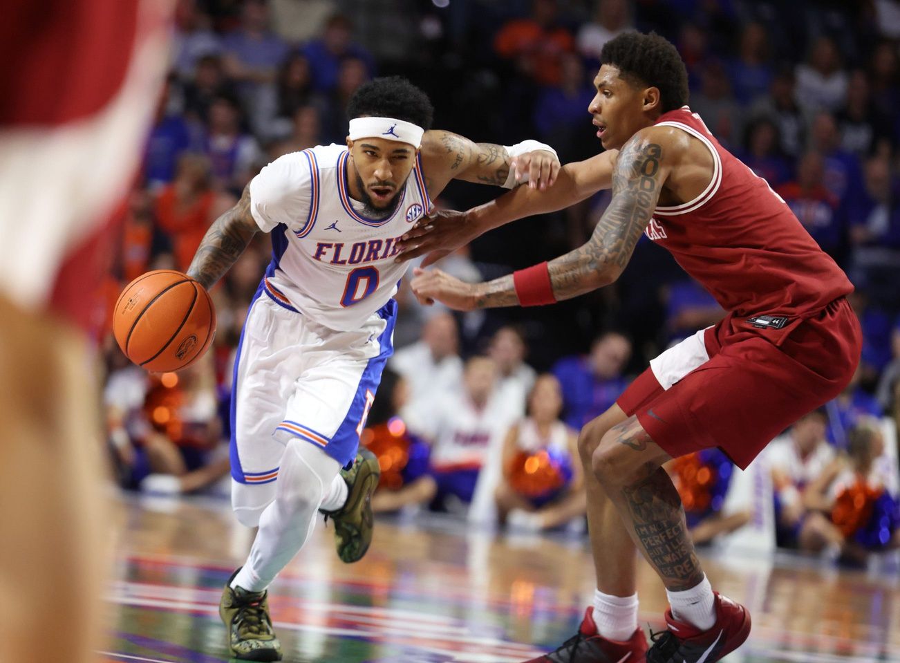 Florida guard Boogie Fland (0) drives on Arkansas guard Meleek Thomas (1) during the second half of an NCAA basketball game at Steven C. O'Connell Center Exactek arena in Gainesville, FL on Saturday, February 28, 2026. [Alan Youngblood/Gainesville Sun]