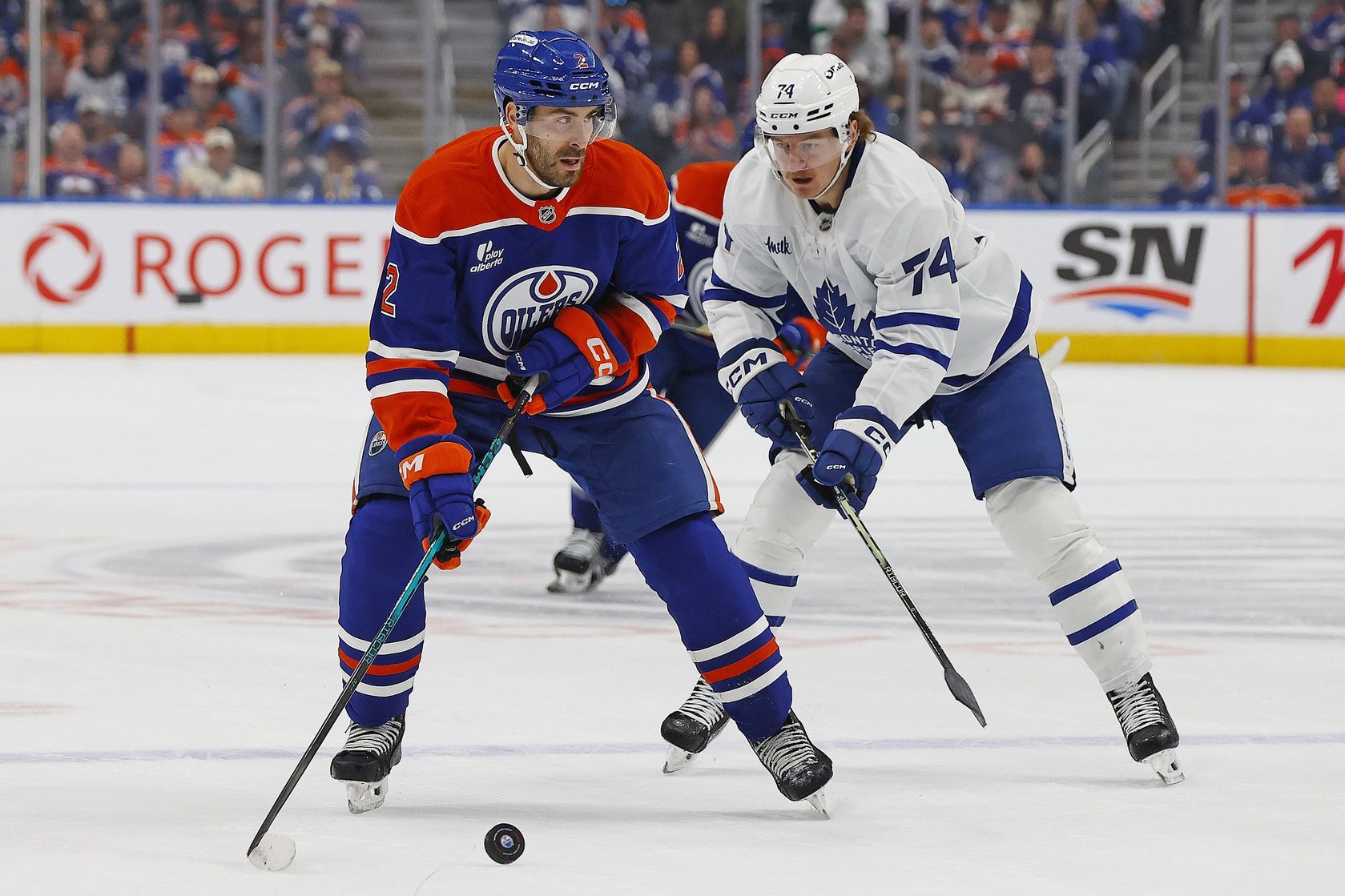 Edmonton Oilers defensemen Evan Bouchard (2) looks to make a pass in front of Toronto Maple Leafs forward Bobby McMann (74) during the first period at Rogers Place.