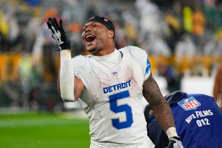Detroit Lions running back David Montgomery (5) celebrates as he runs off the field following the game against the Green Bay Packers at Lambeau Field.