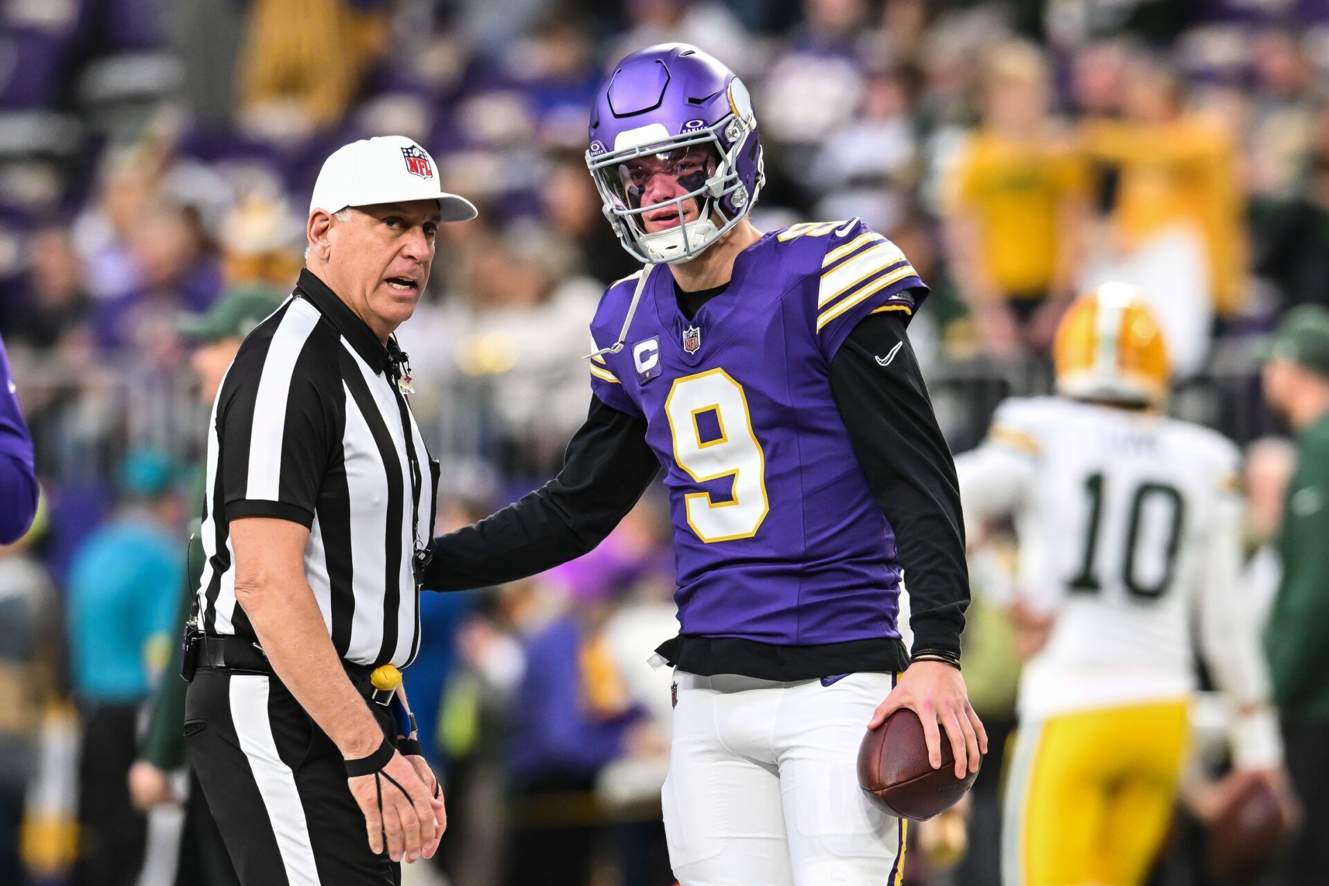 Minnesota Vikings quarterback J.J. McCarthy (9) talks with a referee before the game against the Green Bay Packers at U.S. Bank Stadium.