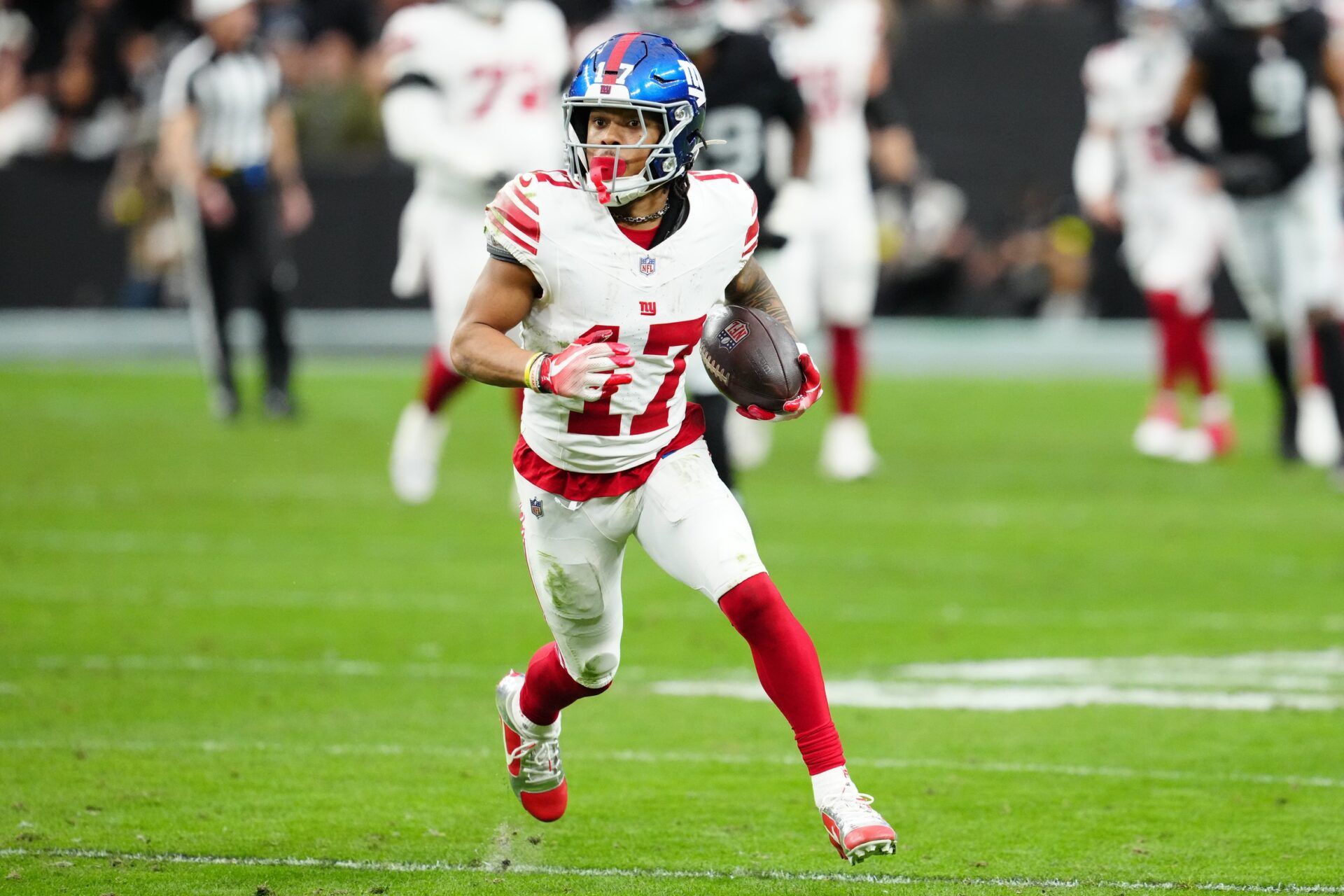 New York Giants wide receiver Wan'Dale Robinson (17) runs with the ball after a catch in the second quarter against the Las Vegas Raiders at Allegiant Stadium.