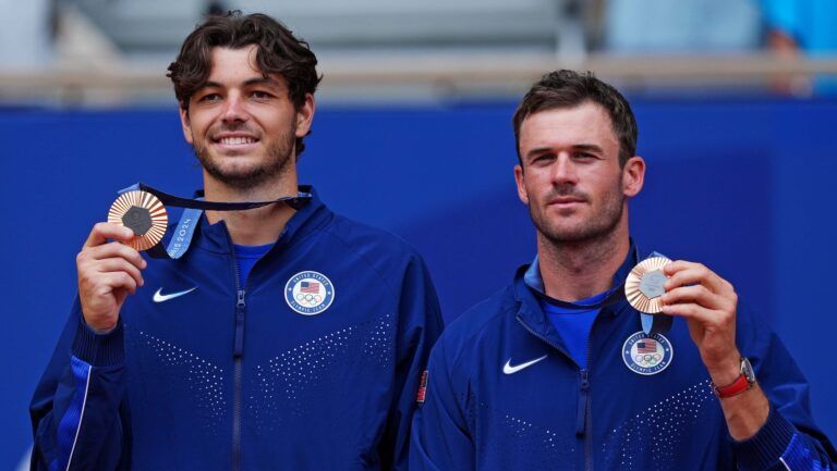 Aug 3, 2024; Paris, Taylor Fritz (USA) and Tommy Paul (USA) celebrate winning the bronze medal in men’s doubles tennis during the Paris 2024 Olympic Summer Games at Stade Roland Garros.