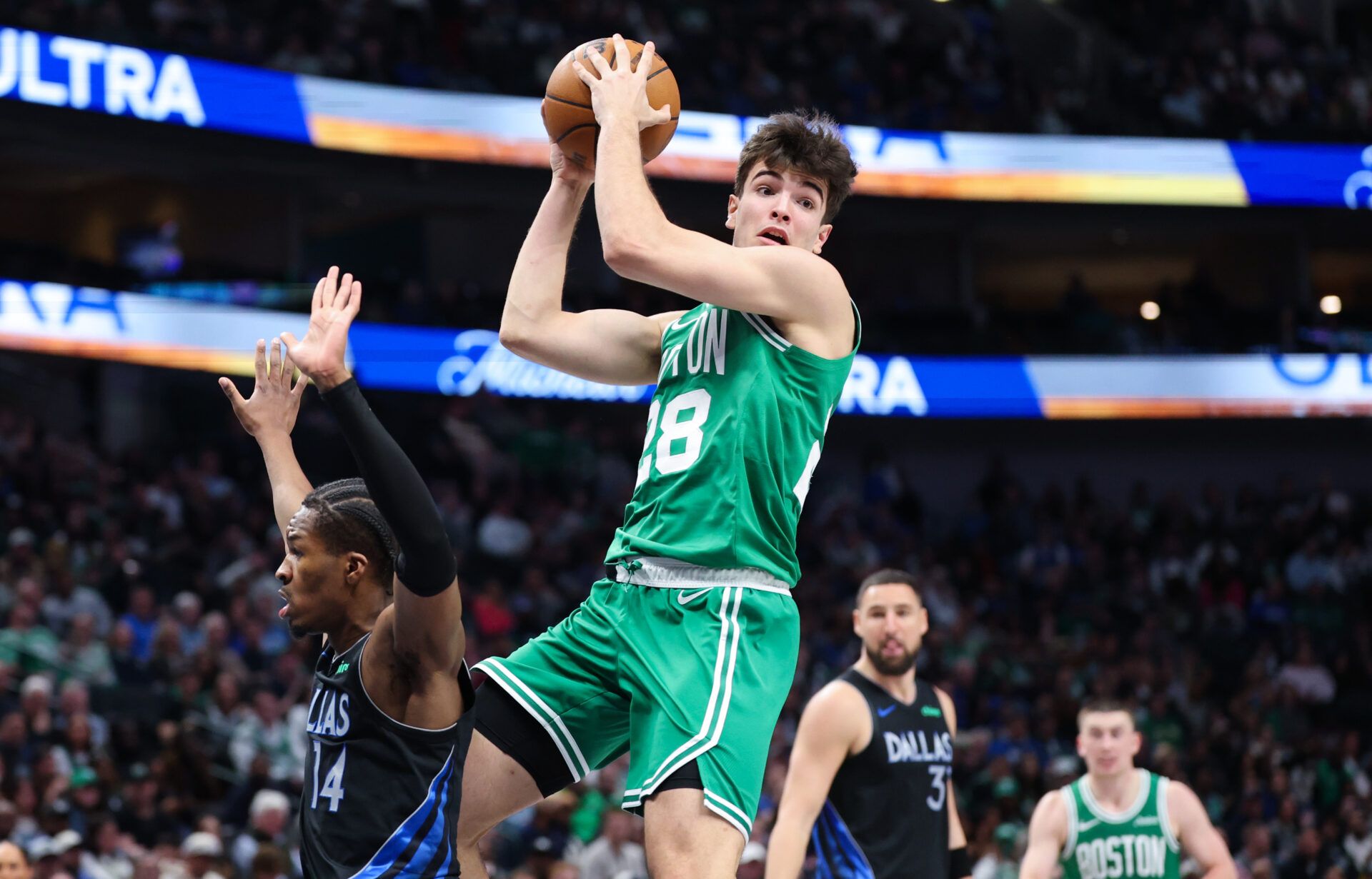 Boston Celtics guard Hugo Gonzalez (28) grabs the ball over Dallas Mavericks guard Miles Kelly (14) during the second half at American Airlines Center.