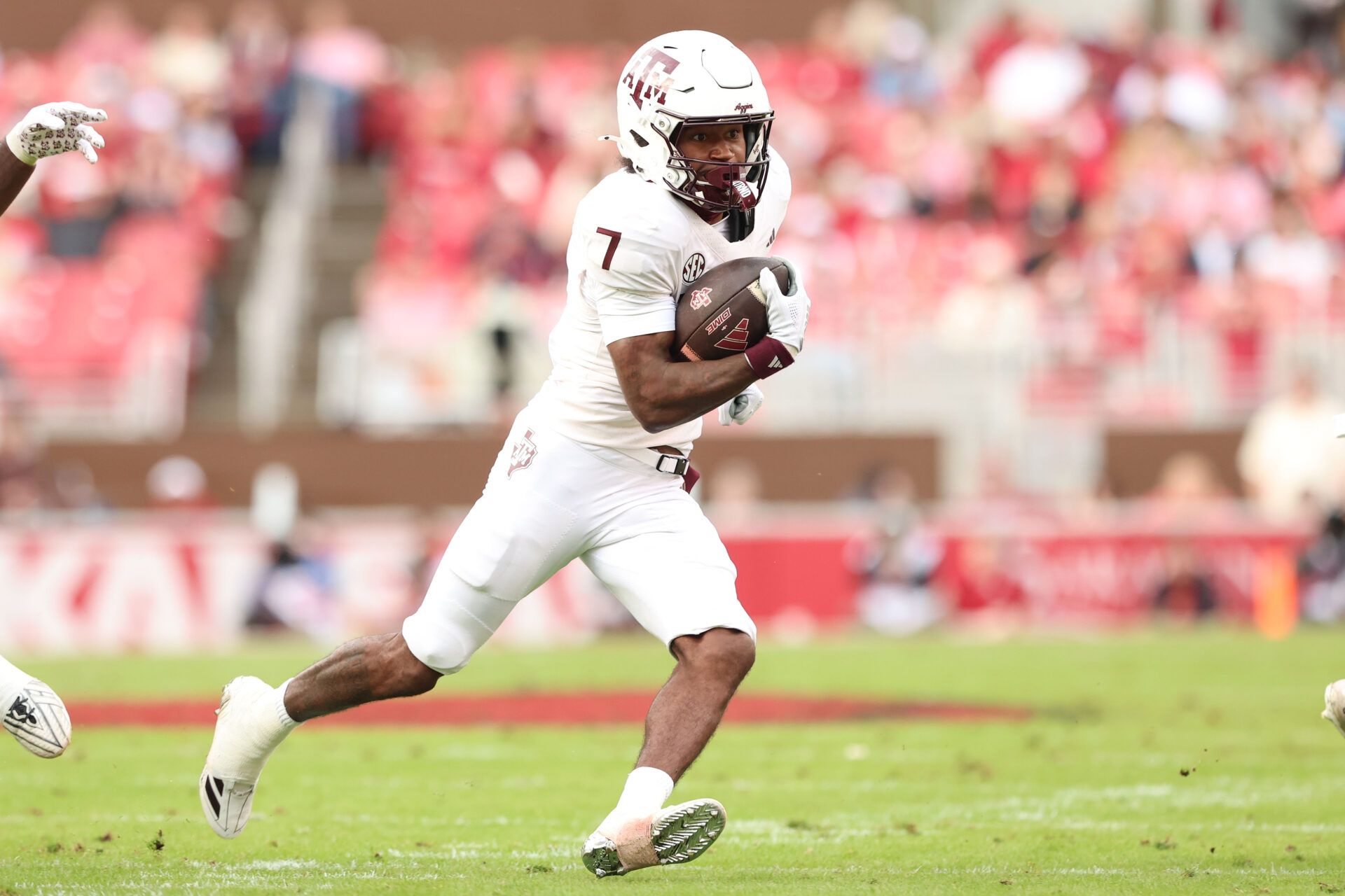 Texas A&M Aggies wide receiver KC Concepcion (7) runs after a catch during the first quarter against the Arkansas Razorbacks at Donald W. Reynolds Razorback Stadium.