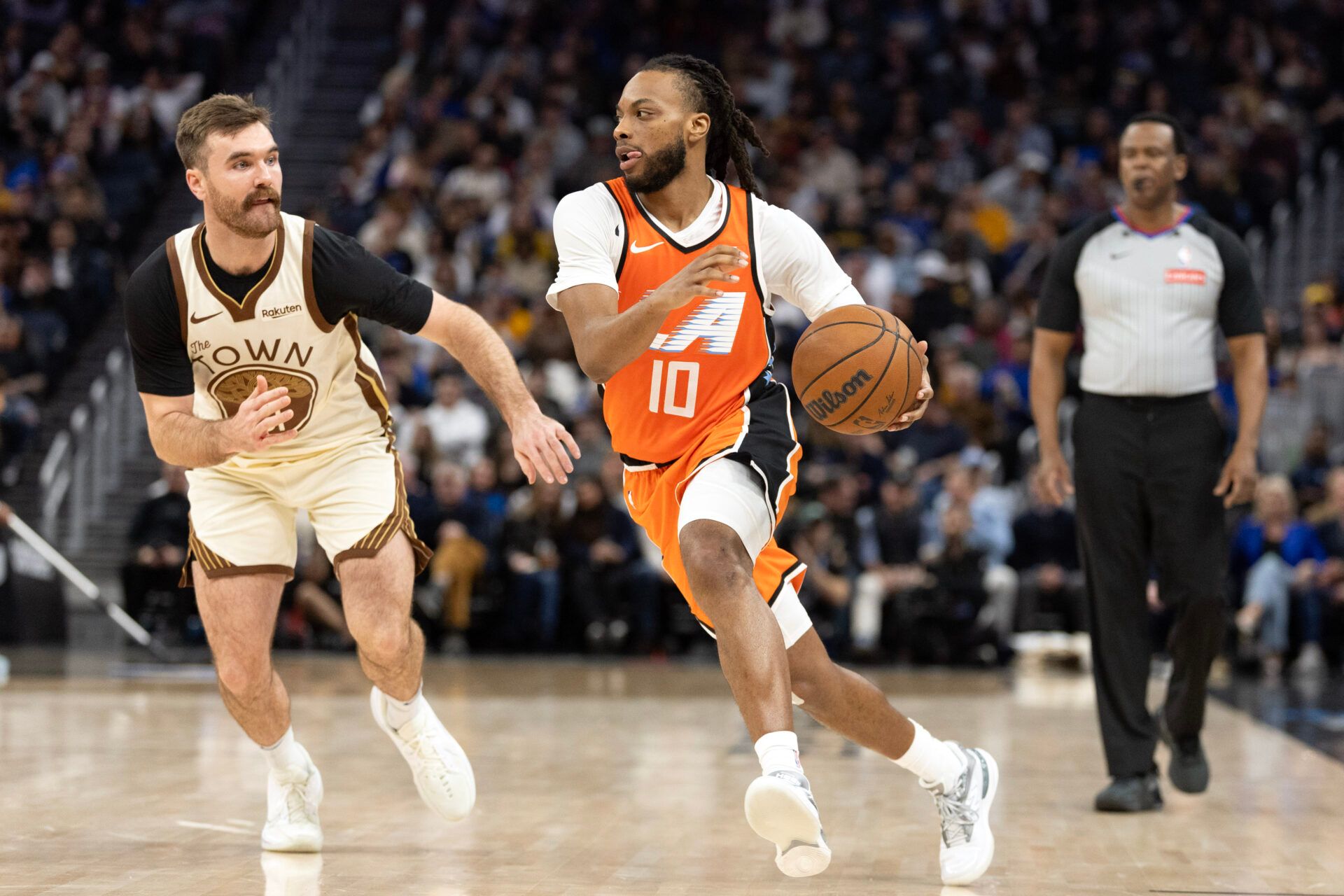 Los Angeles Clippers guard Darius Garland (10) drives past Golden State Warriors guard Pat Spencer (61) during the third quarter at Chase Center.