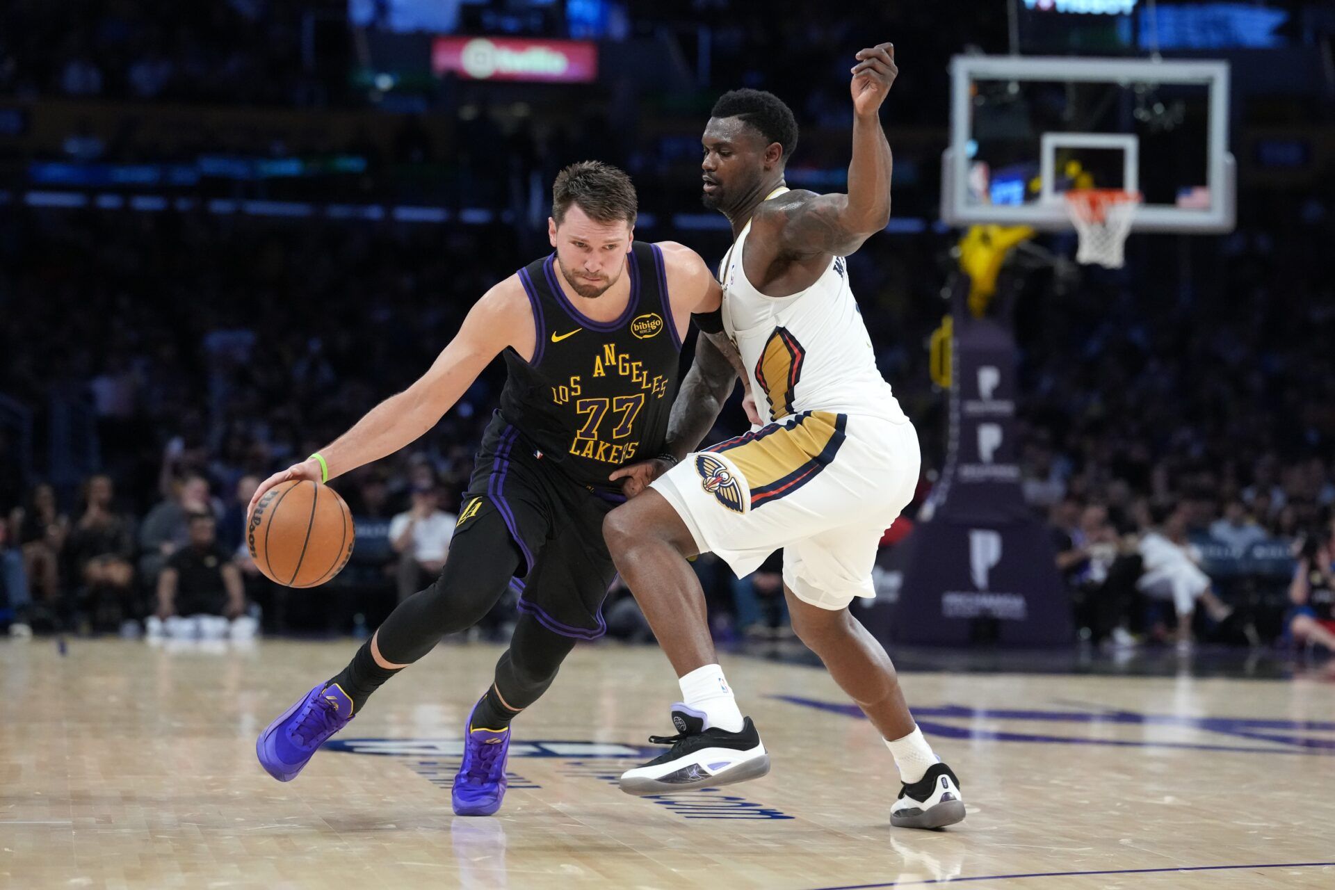 Los Angeles Lakers guard Luka Doncic (77) dribbles the ball against New Orleans Pelicans guard Saddiq Bey (41) in the second half at Crypto.com Arena.