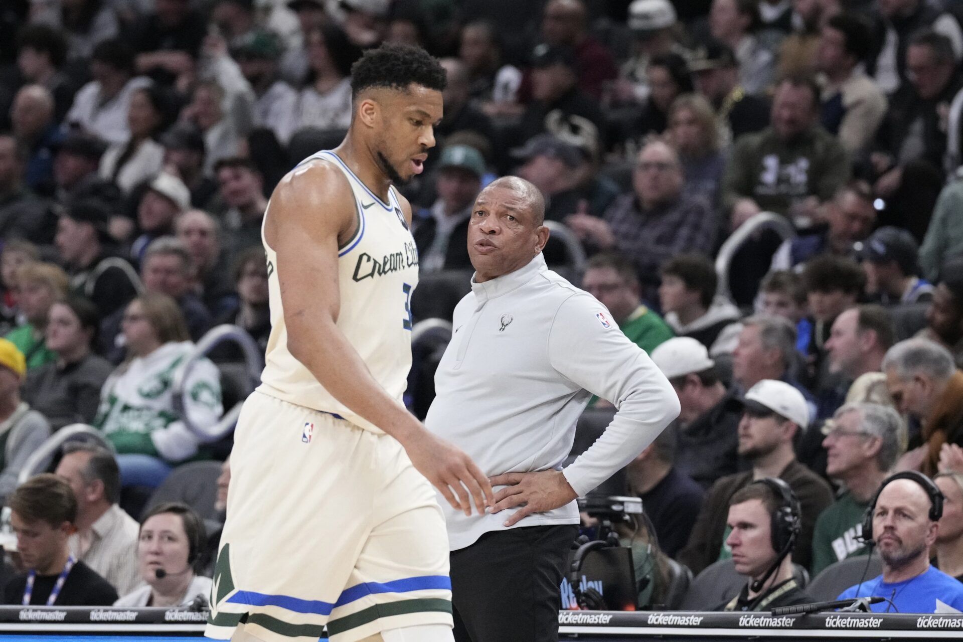 Milwaukee Bucks forward Giannis Antetokounmpo (34) comes out of the game near the end of the second quarter and walks past Milwaukee Bucks head coach Doc Rivers as they compete against the Boston Celtics at Fiserv Forum.