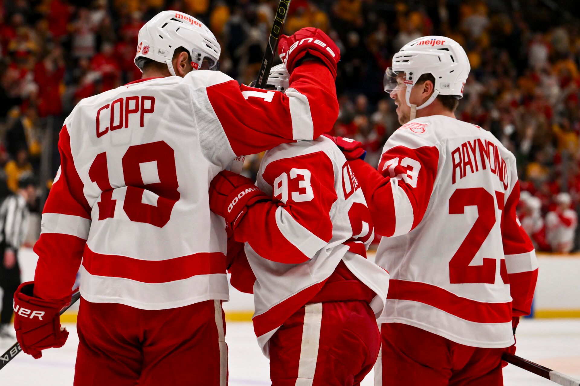 Detroit Red Wings goaltender Cam Talbot (39) celebrates his goal with center Andrew Copp (18) and left wing Lucas Raymond (23) against the Nashville Predators during the third period at Bridgestone Arena.