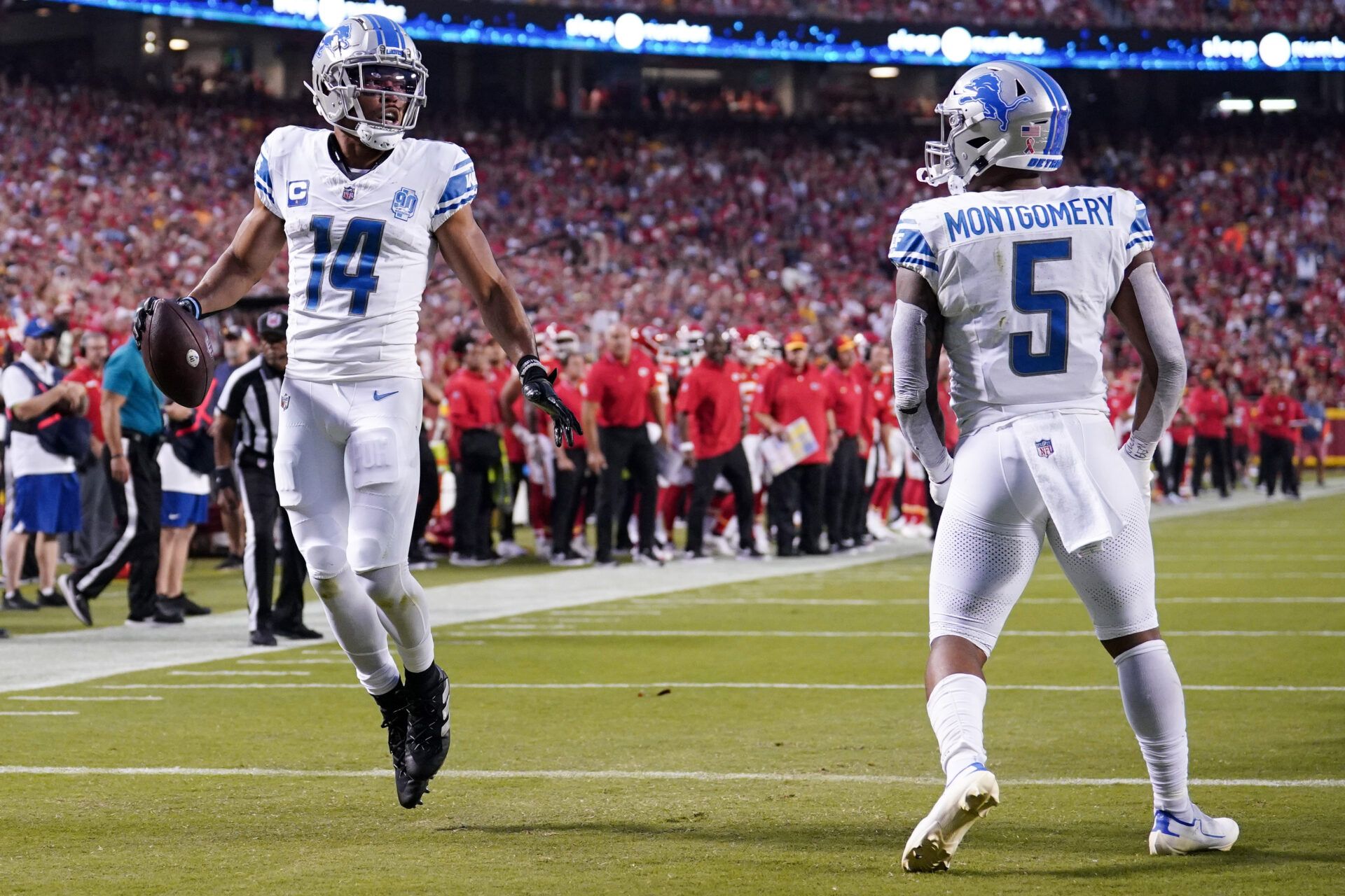 Detroit Lions wide receiver Amon-Ra St. Brown (14) celebrates with running back David Montgomery (5) after scoring against the Kansas City Chiefs during the game at GEHA Field at Arrowhead Stadium.