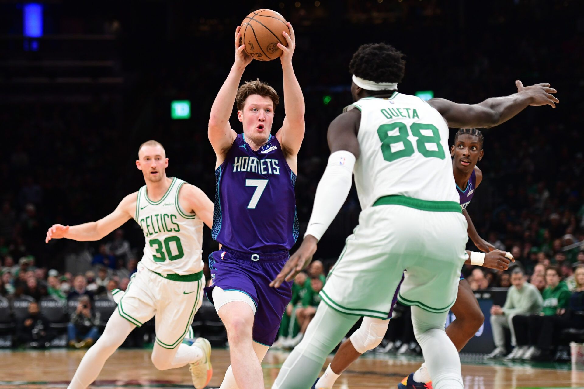 Charlotte Hornets guard Kon Knueppel (7) controls the ball while Boston Celtics center Neemias Queta (88) defends during the second half at TD Garden.