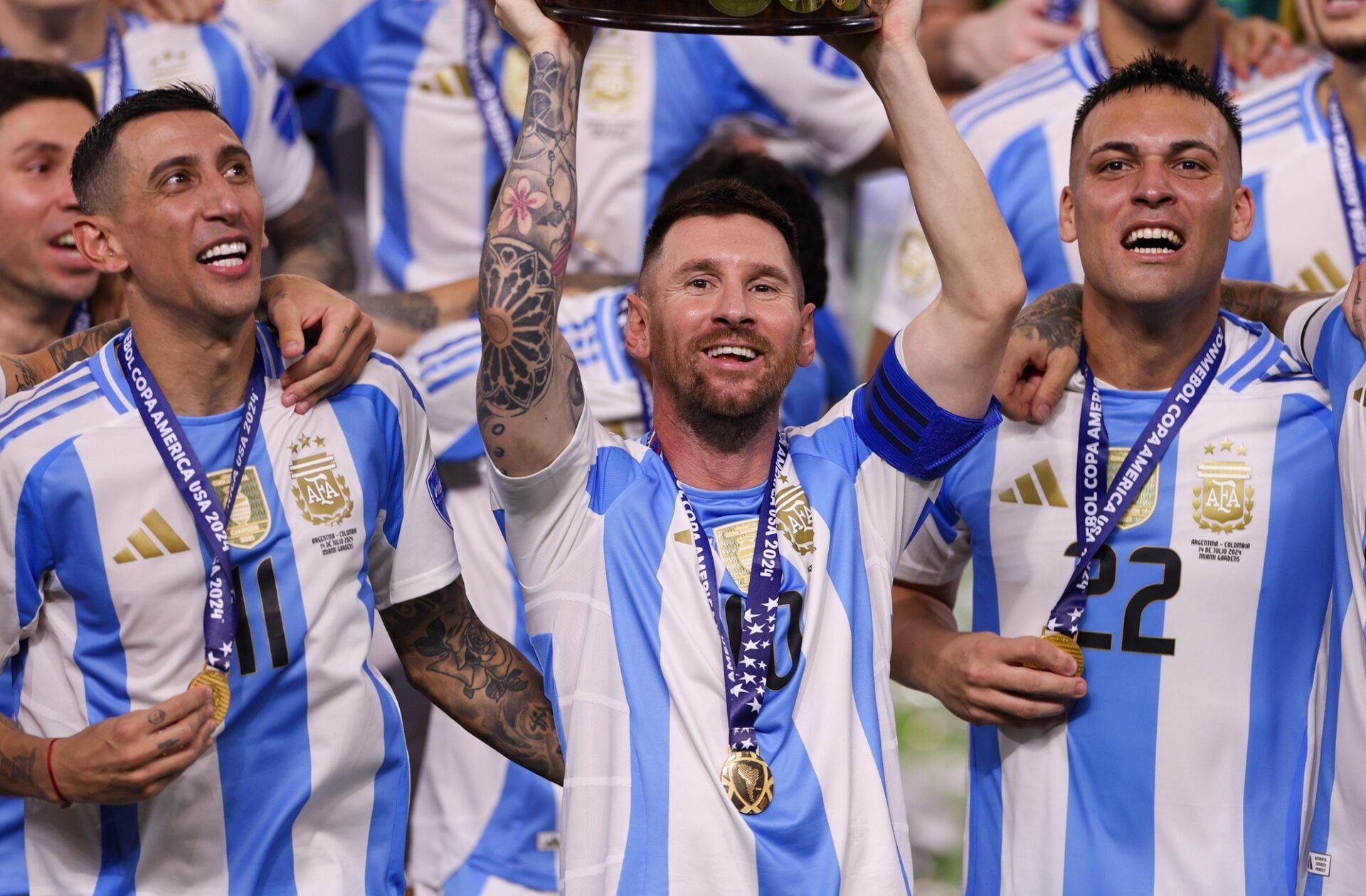 Argentina forward Lionel Messi (10) midfielder Angel Di Maria (11) forward Lautaro Martínez (22) and defender Nicolas Otamendi (19) celebrate after winning the Copa America Final against Colombia at Hard Rock Stadium.