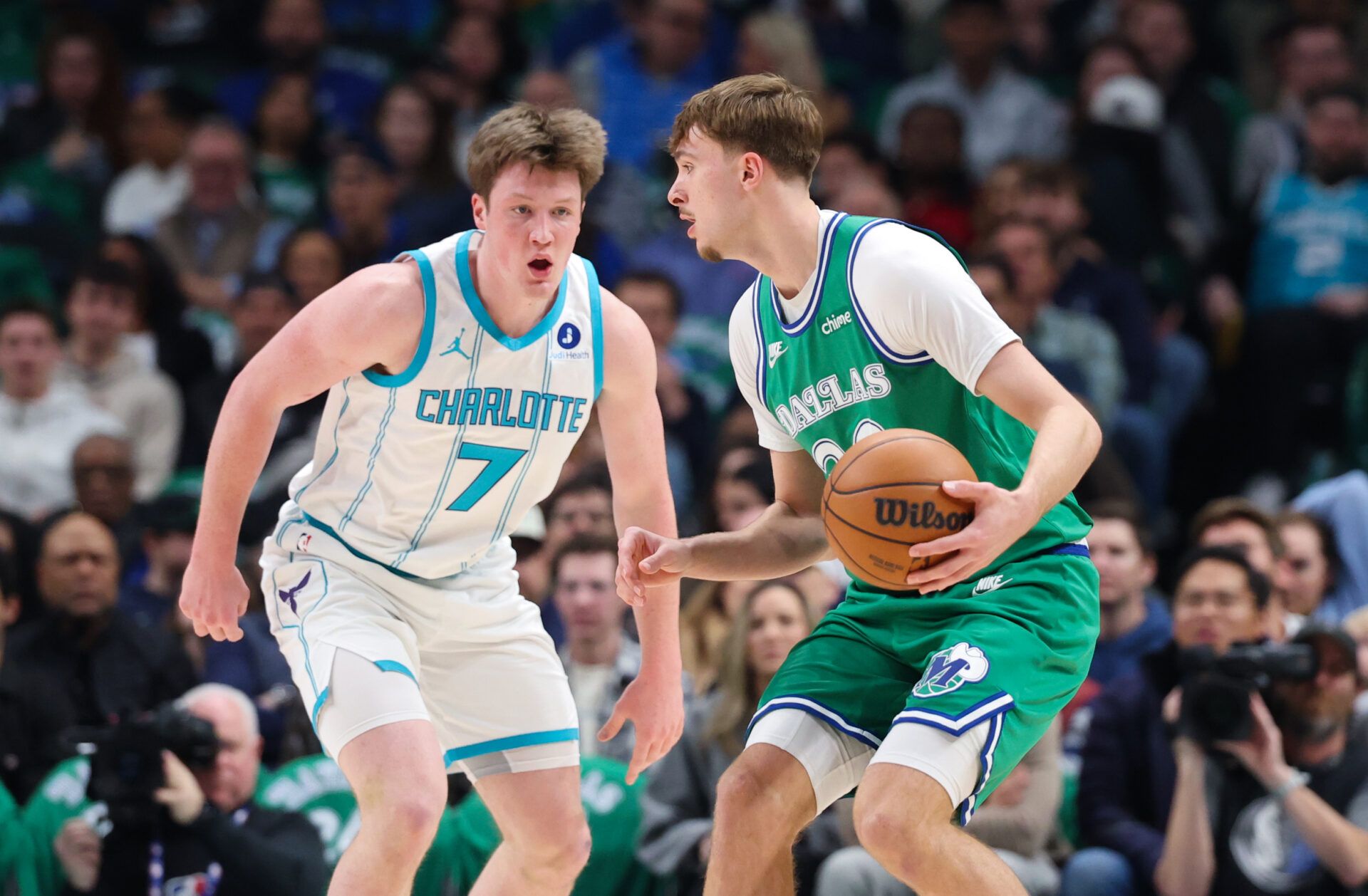 Dallas Mavericks forward Cooper Flagg (32) controls the ball as Charlotte Hornets guard Kon Knueppel (7) defends during the first quarter at American Airlines Center.