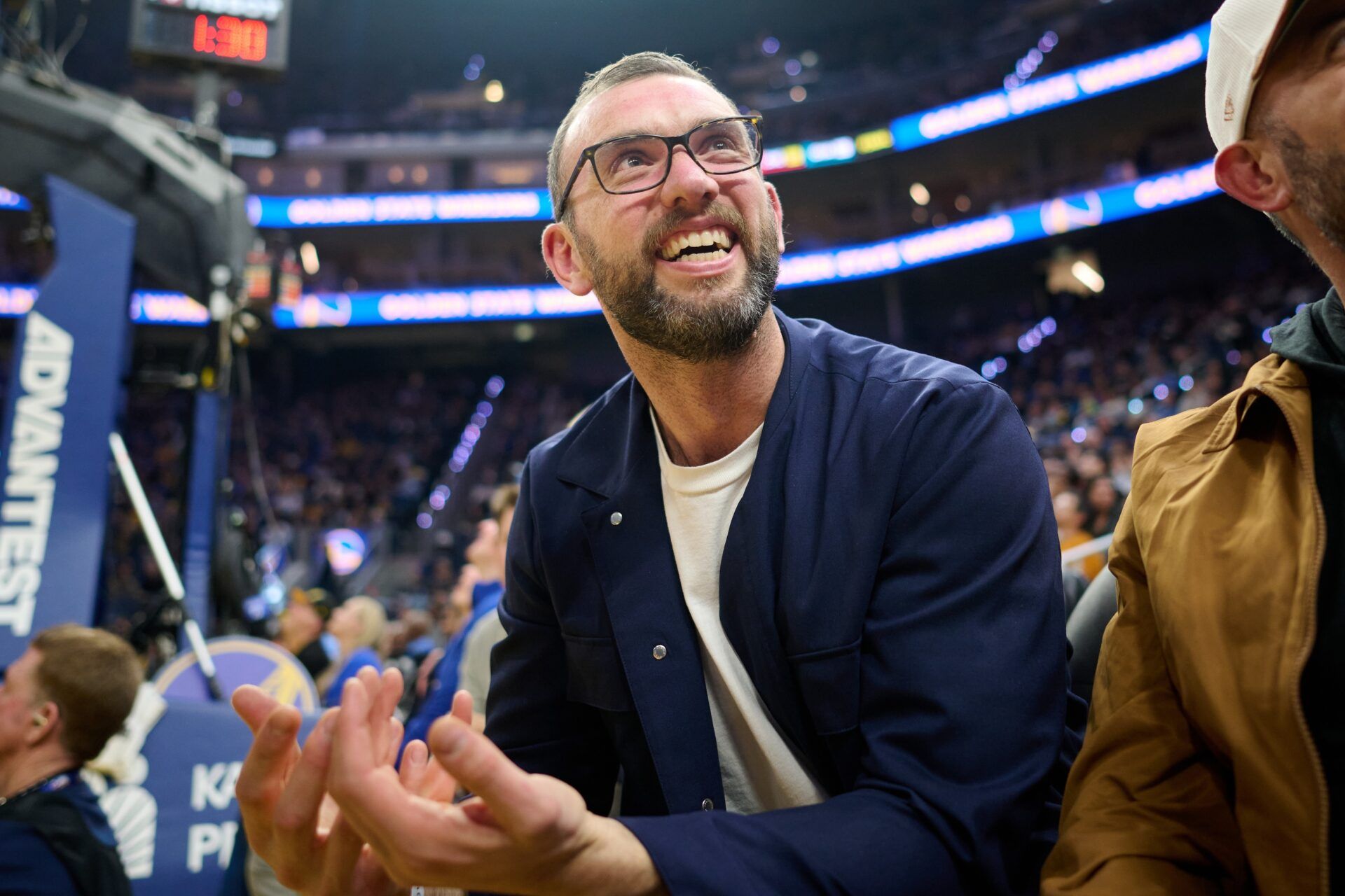 General manager of the Stanford Cardinal football program Andrew Luck looks on during the first quarter of the game between the Golden State Warriors and the Minnesota Timberwolves at Chase Center.