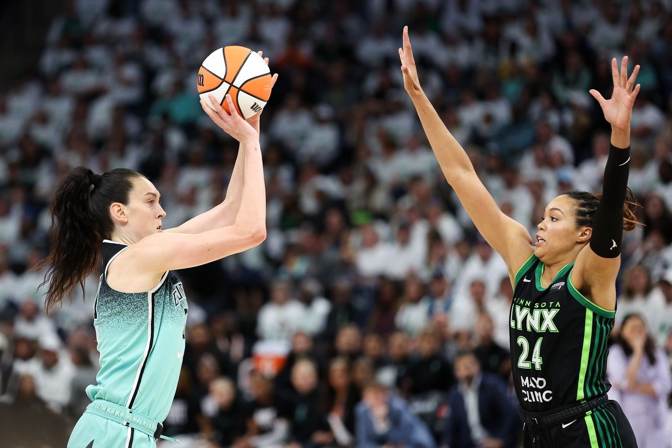 New York Liberty forward Breanna Stewart (30) shoots as Minnesota Lynx forward Napheesa Collier (24) defends during the second half of game three of the 2024 WNBA Finals at Target Center.