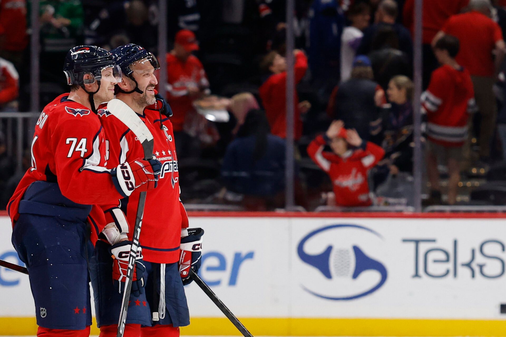 Washington Capitals defenseman John Carlson (74) and Capitals left wing Alex Ovechkin (8) celebrate after their game against the Winnipeg Jets at Capital One Arena.