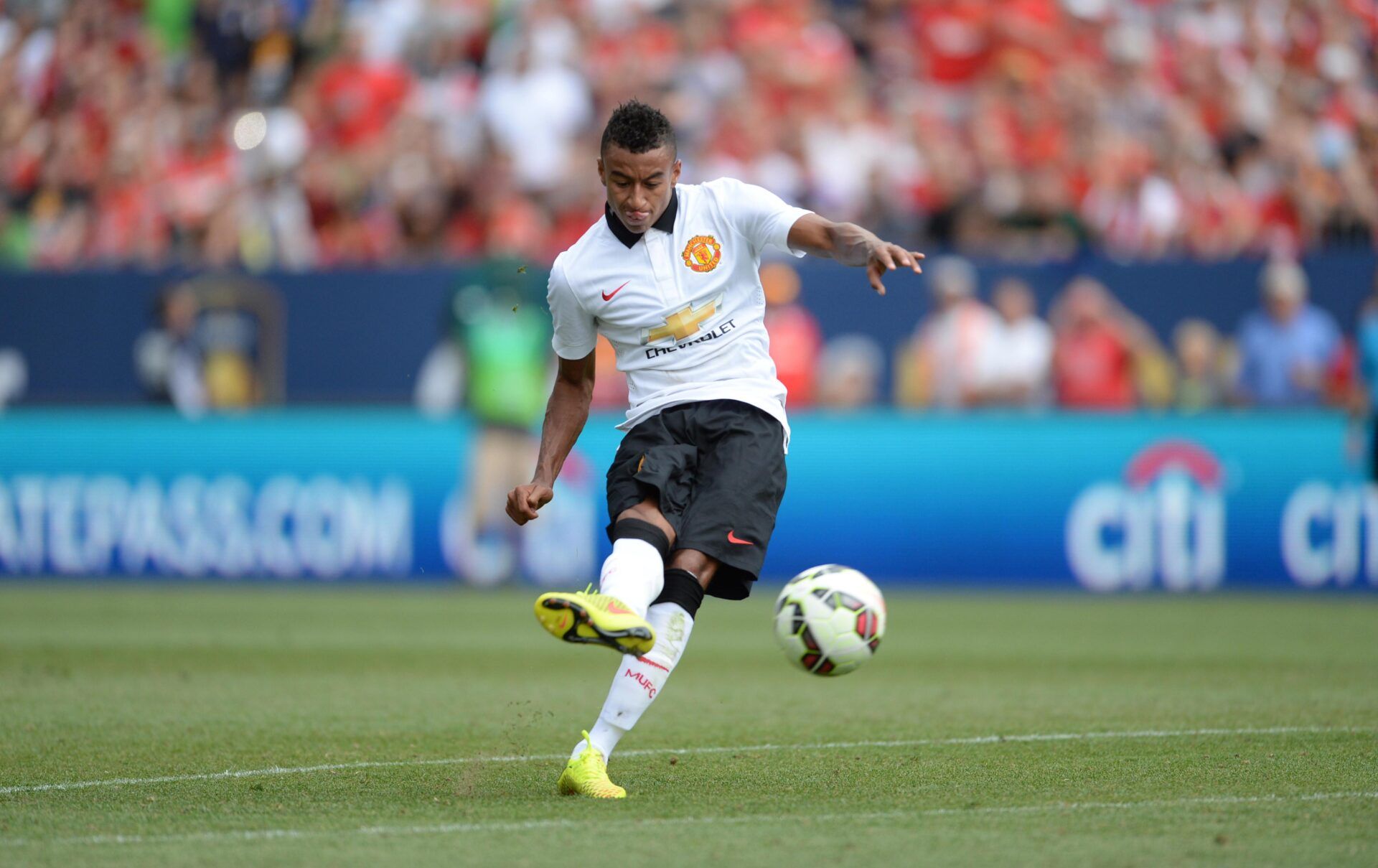 Manchester United midfielder Jesse Lingard (35) kicks the soccer ball in the second half against AS Roma at Sports Authority Field. Manchester United defeated AS Roma 3-2.