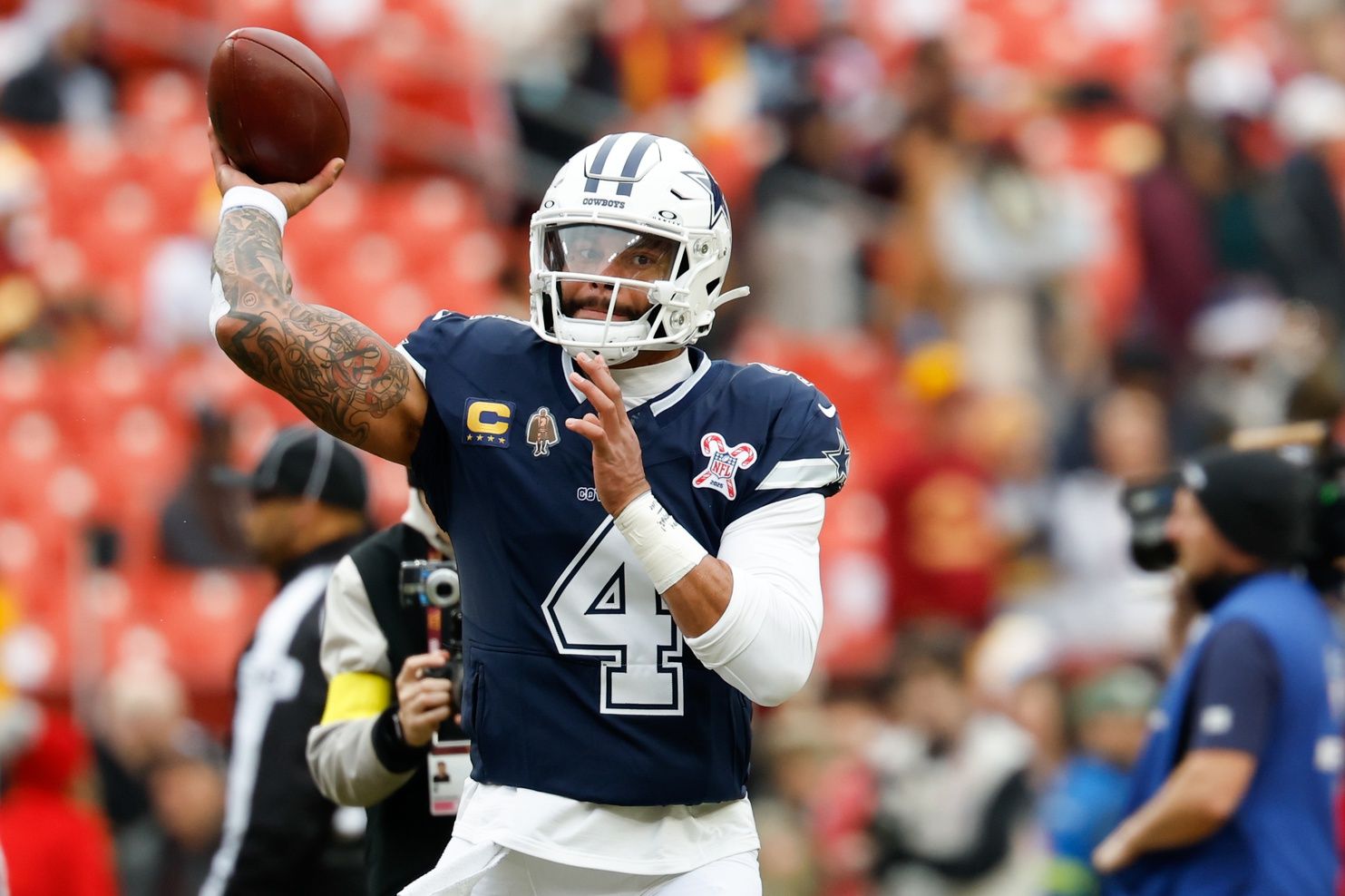 Dallas Cowboys quarterback Dak Prescott (4) warms up before the game against the Washington Commanders at Northwest Stadium.