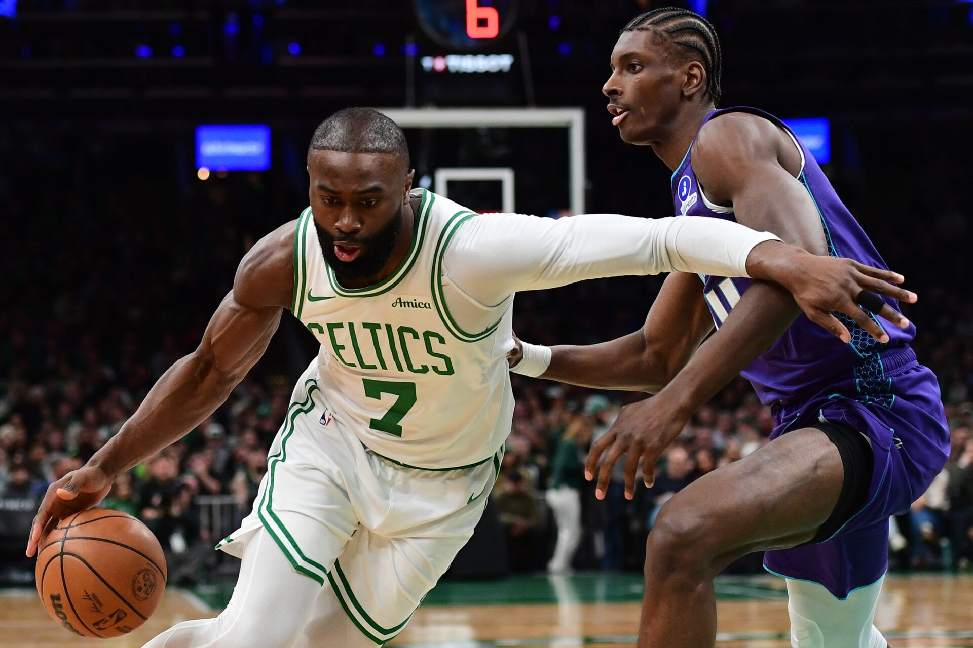 Boston Celtics guard Jaylen Brown (7) controls the ball while Charlotte Hornets forward Moussa Diabate (14) defends during the first half at TD Garden.