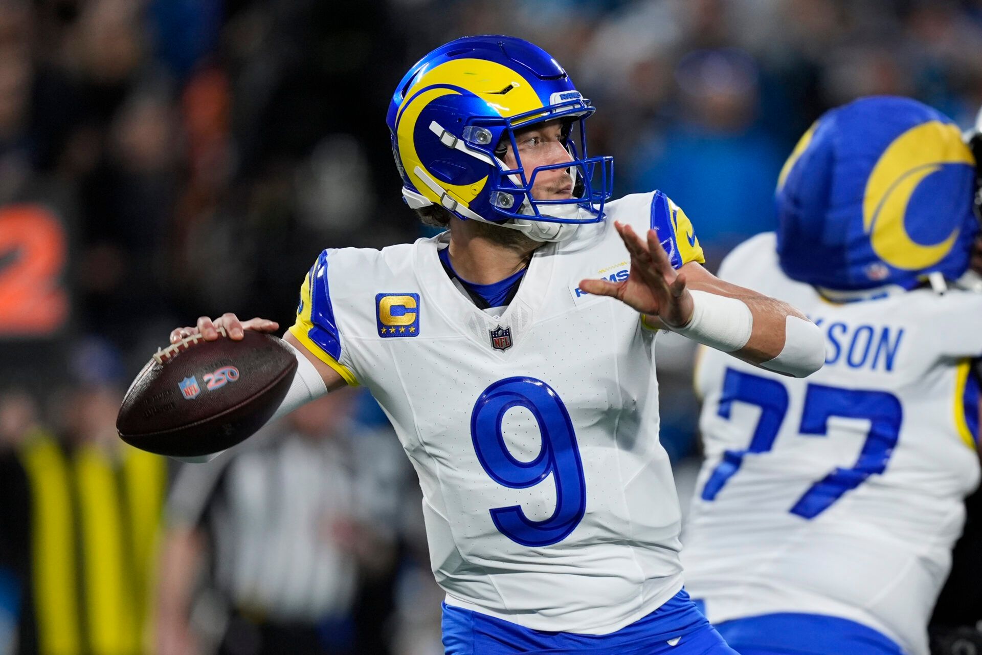 Los Angeles Rams quarterback Matthew Stafford (9) drops back to pass against the Carolina Panthers in the first half during the NFC Wild Card Round game at Bank of America Stadium.