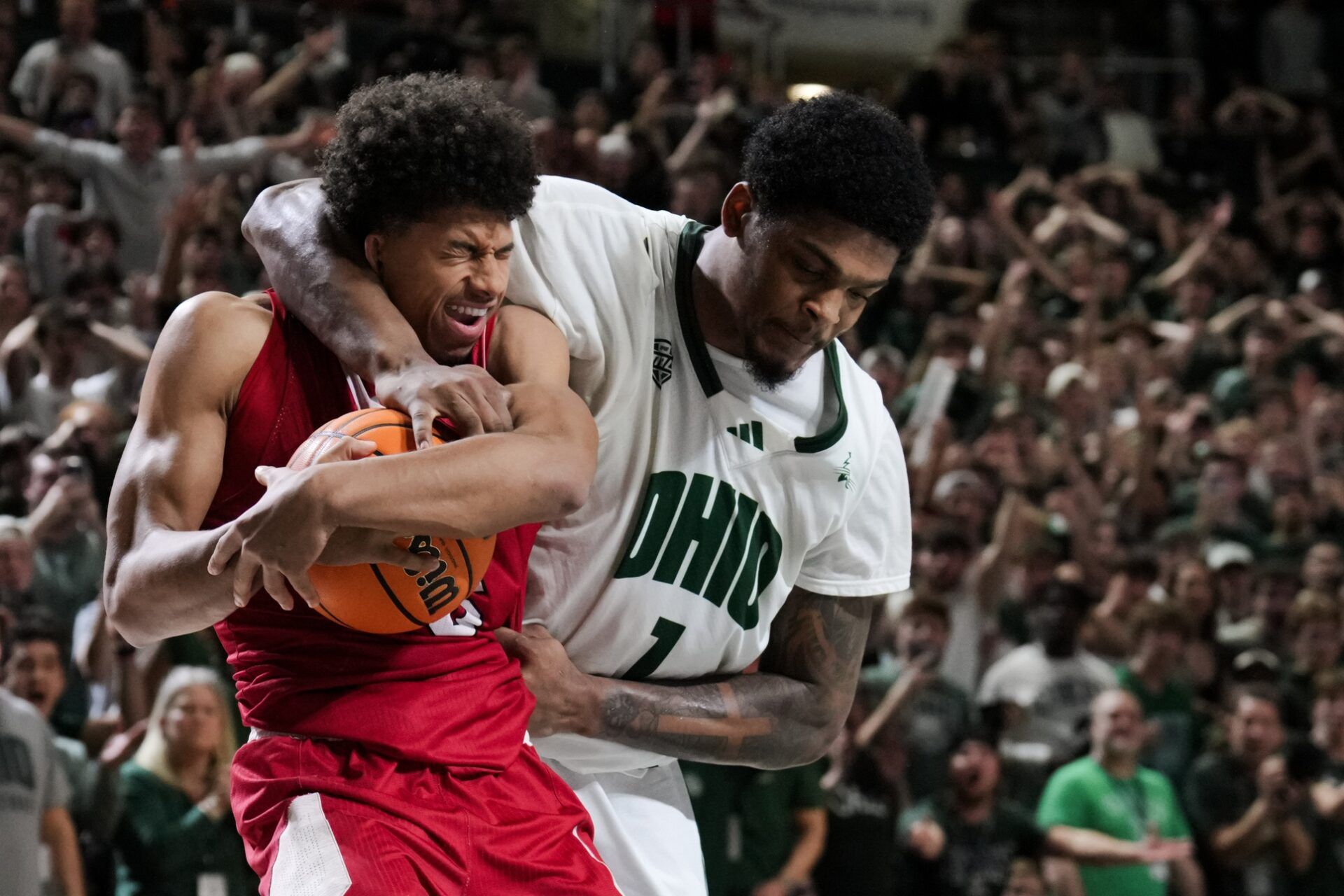 Miami (OH) RedHawks guard Justin Kirby (6) battles for the rebound against Ohio Bobcats forward Javan Simmons (1) in the overtime period at the Convocation Center.
