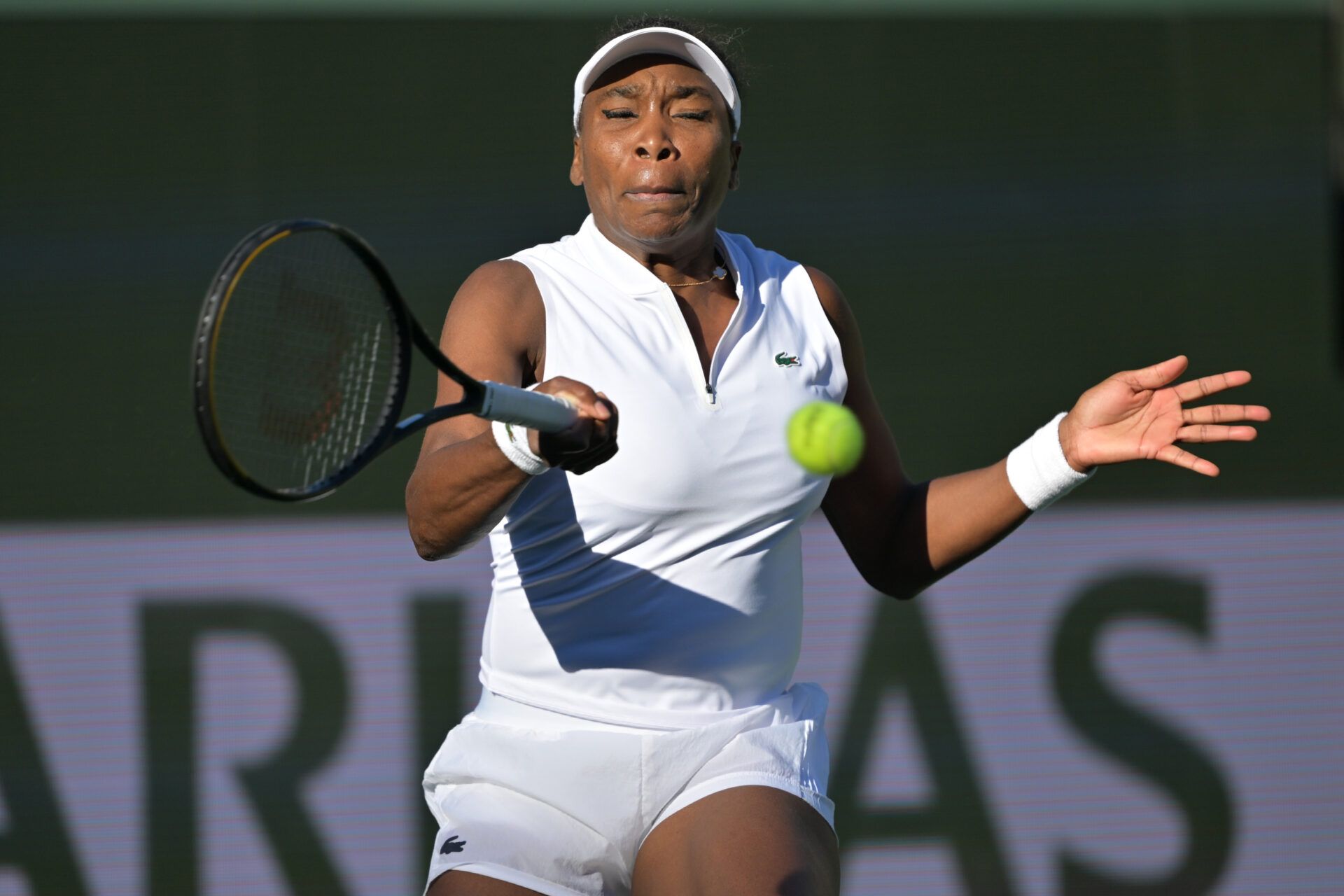 Venus Williams (USA) hits a shot during her first round match against Diane Parry (FRA) during the BNP Paribas Open at the Indian Wells Tennis Garden.