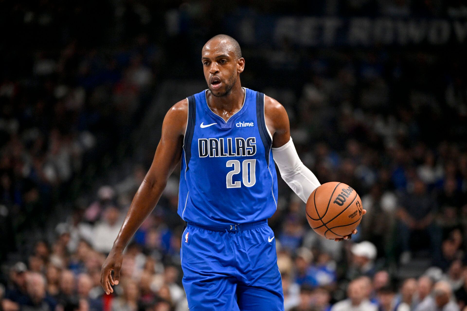 Dallas Mavericks forward Khris Middleton (20) brings the ball up court against the Sacramento Kings during the first quarter at the American Airlines Center.