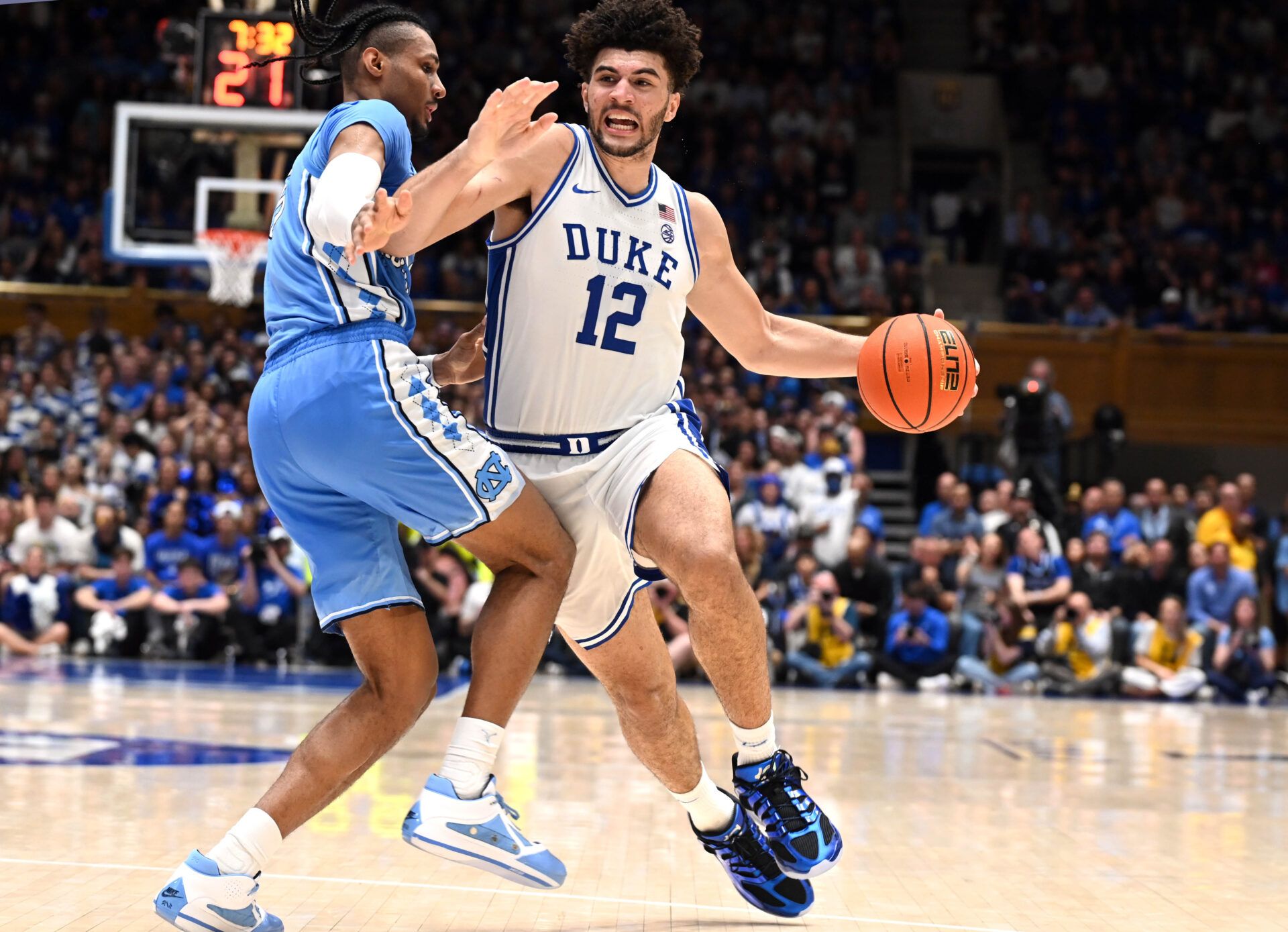 Duke Blue Devils forward Cameron Boozer (12) drives to the basket as North Carolina Tar Heels forward Jarin Stevenson (15) defends during the second half at Cameron Indoor Stadium.  The Duke Blue Devils won 76-61.
