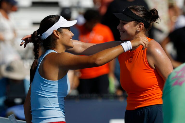 Emma Raducanu (GBR)(L) hugs Amanda Anisimova (USA)(R) at the net after their match on day seven of the Miami Open at Hard Rock Stadium.