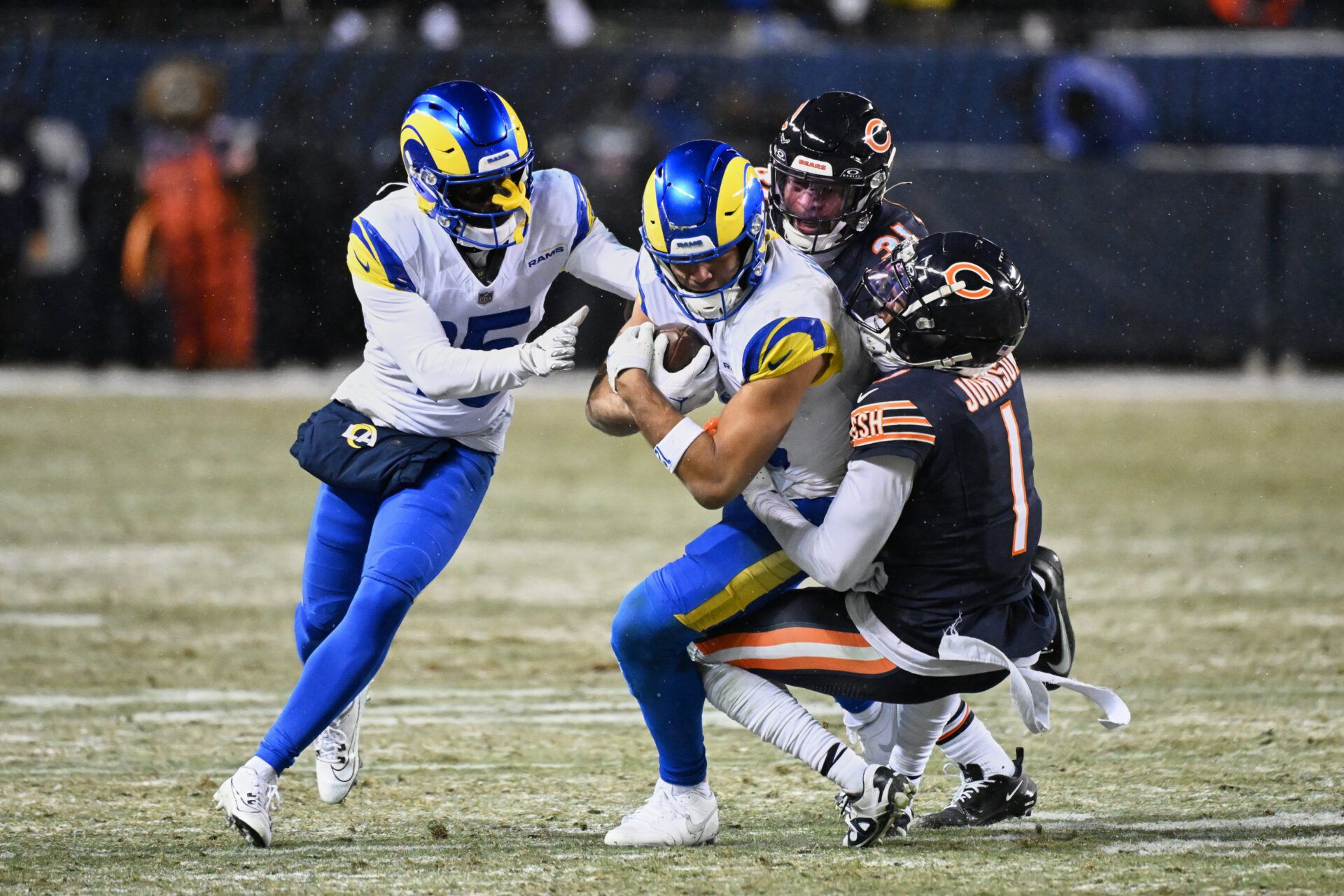 Los Angeles Rams wide receiver Puka Nacua (12) runs after the catch against Chicago Bears cornerback Jaylon Johnson (1) during overtime of an NFC Divisional Round game at Soldier Field.