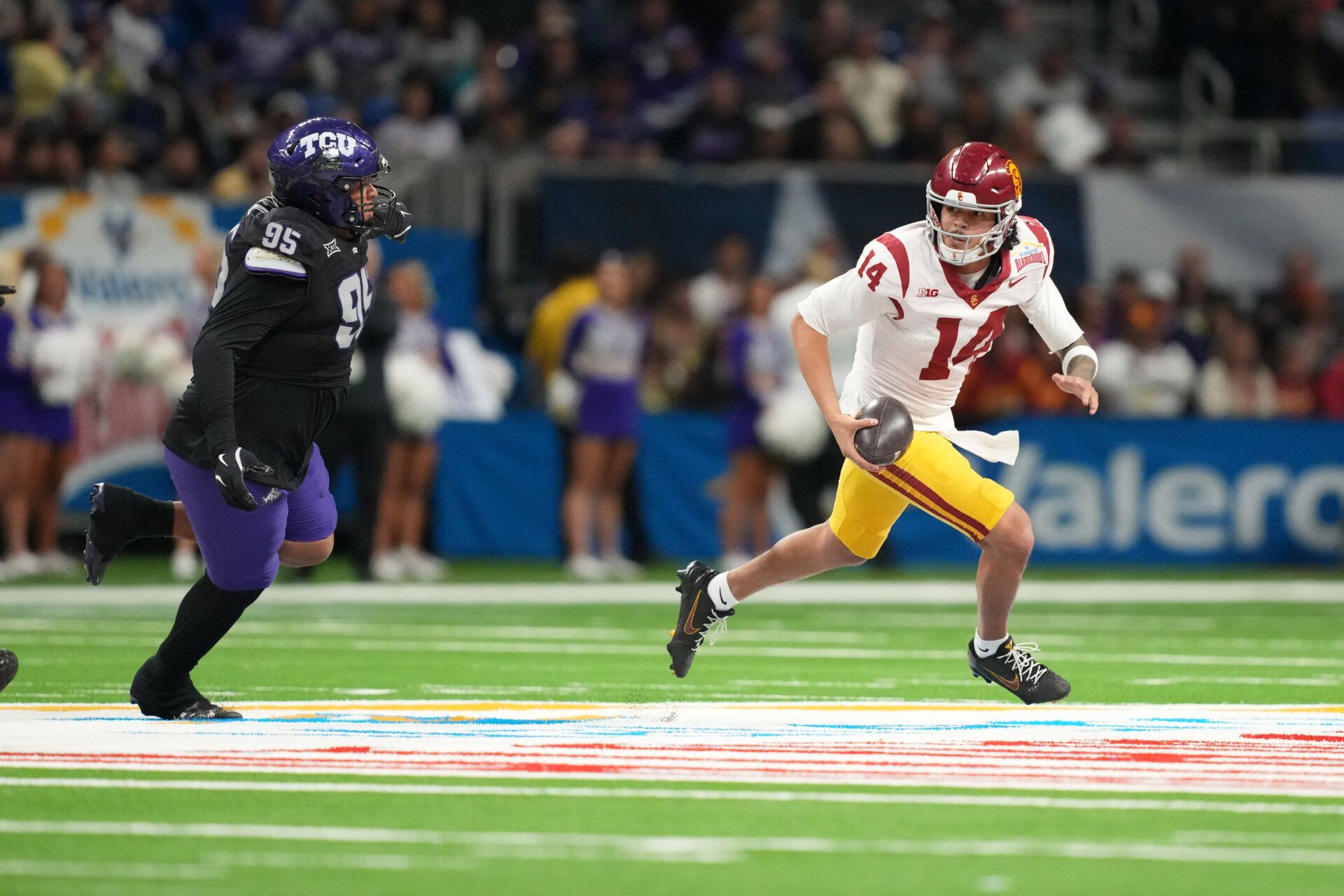 Southern California Trojans quarterback Jayden Maiava (14) carries the ball against TCU Horned Frogs defensive tackle Markis Deal (95) in the second half during the Alamo Bowl at Alamodome.