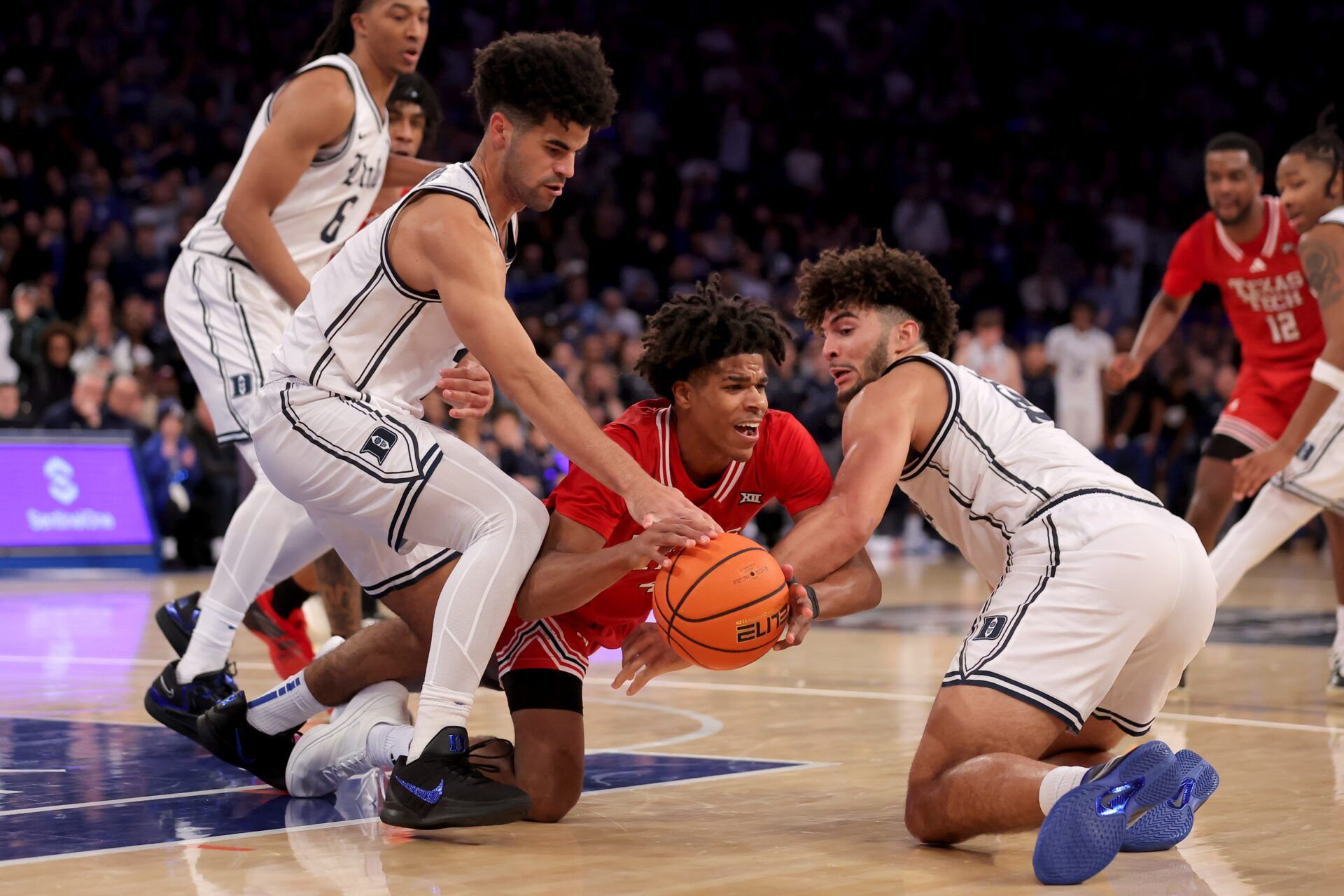 Texas Tech Red Raiders guard Christian Anderson (4) fights for the ball against Duke Blue Devils guard Cayden Boozer (2) and forward Cameron Boozer (12) during the second half at Madison Square Garden.
