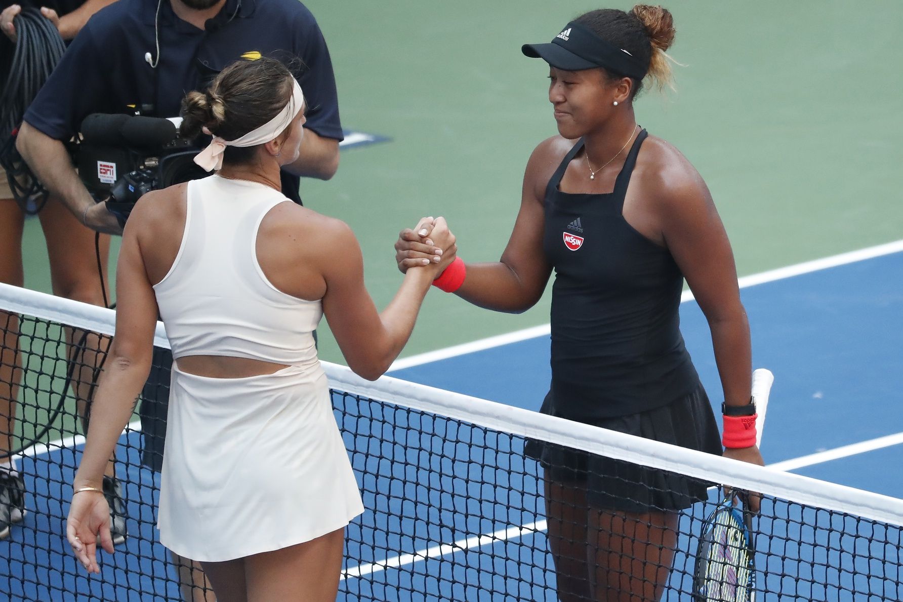 Naomi Osaka of Japan (R) shakes hands with Aryna Sabalenka of Belarus (L) after their match in the fourth round on day eight of the US Open at USTA Billie Jean King National Tennis Center.