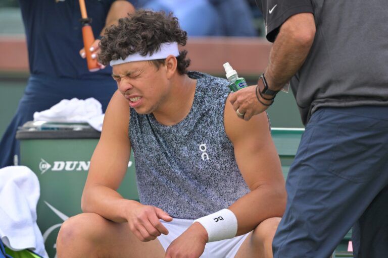 Ben Shelton (USA) reacts after getting a shot of throat spray from the medical team during his second round match against Reilly Opelka (USA) in the BNP Paribas Open at the Indian Wells Tennis Garden.
