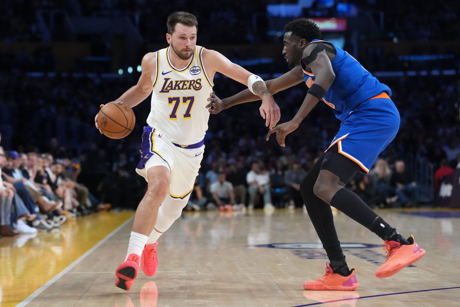 Los Angeles Lakers guard Luka Doncic (77) dribbles against New York Knicks forward Mohamed Diawara (51) in the second half at Crypto.com Arena.
