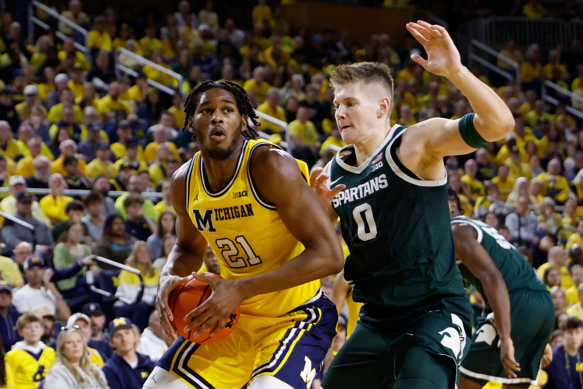 Michigan Wolverines forward Morez Johnson Jr. (21) is defended by Michigan State Spartans forward Jaxon Kohler (0) in the first half at Crisler Center.