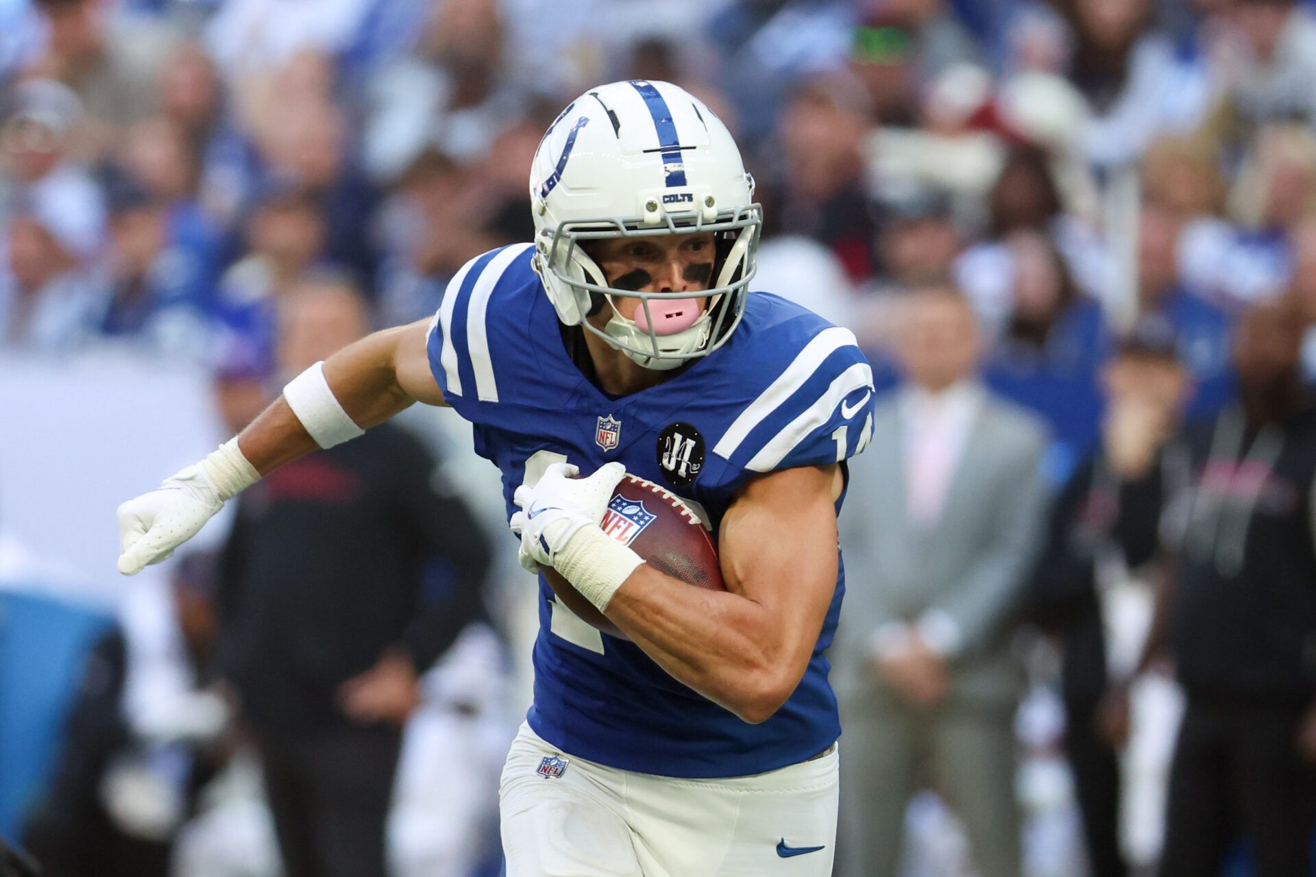Indianapolis Colts wide receiver Alec Pierce (14) carries the ball against the Arizona Cardinals during the fourth quarter of the game at Lucas Oil Stadium.