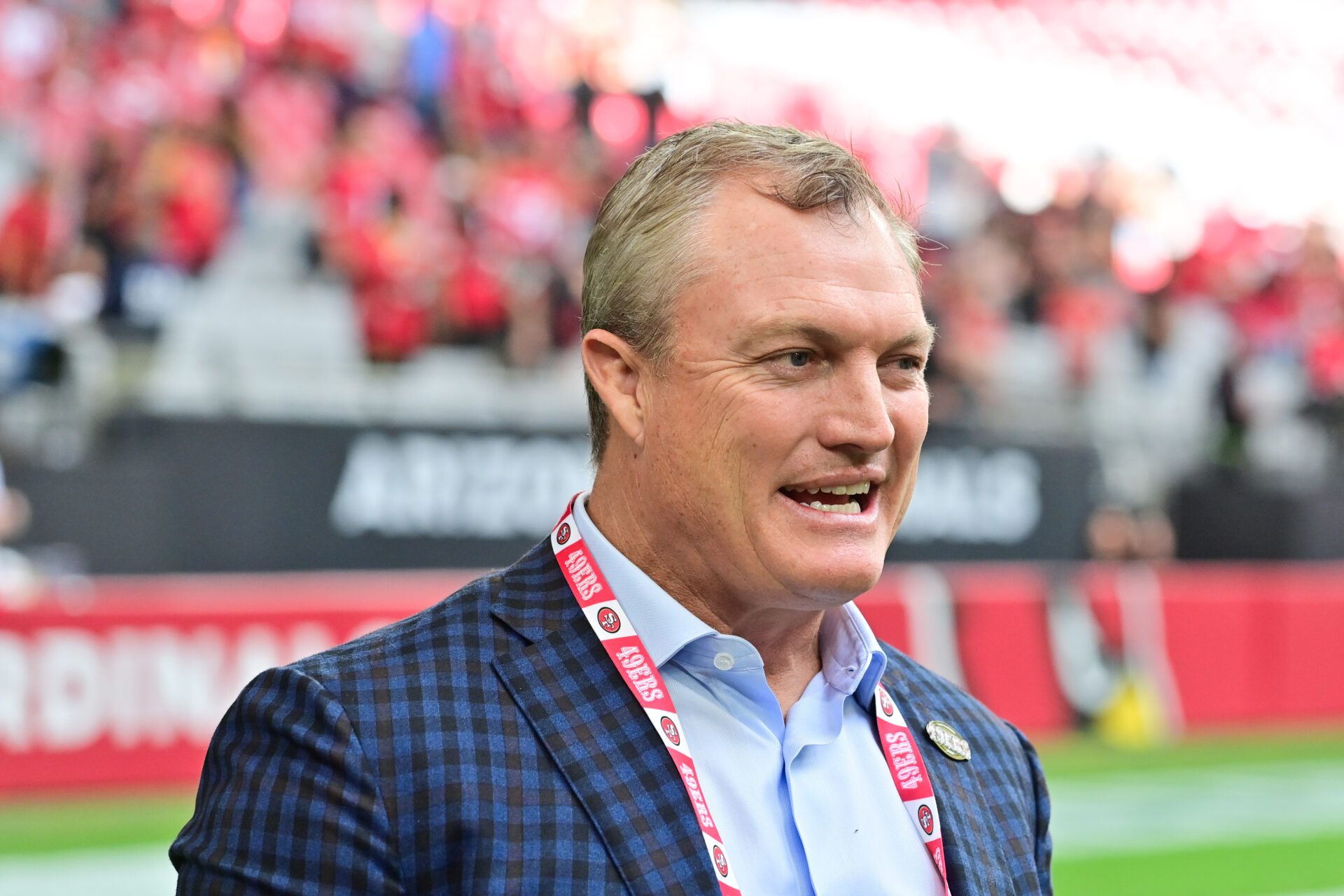 San Francisco 49ers general manager John Lynch speaks on the sidelines before the game against the Arizona Cardinals at State Farm Stadium.