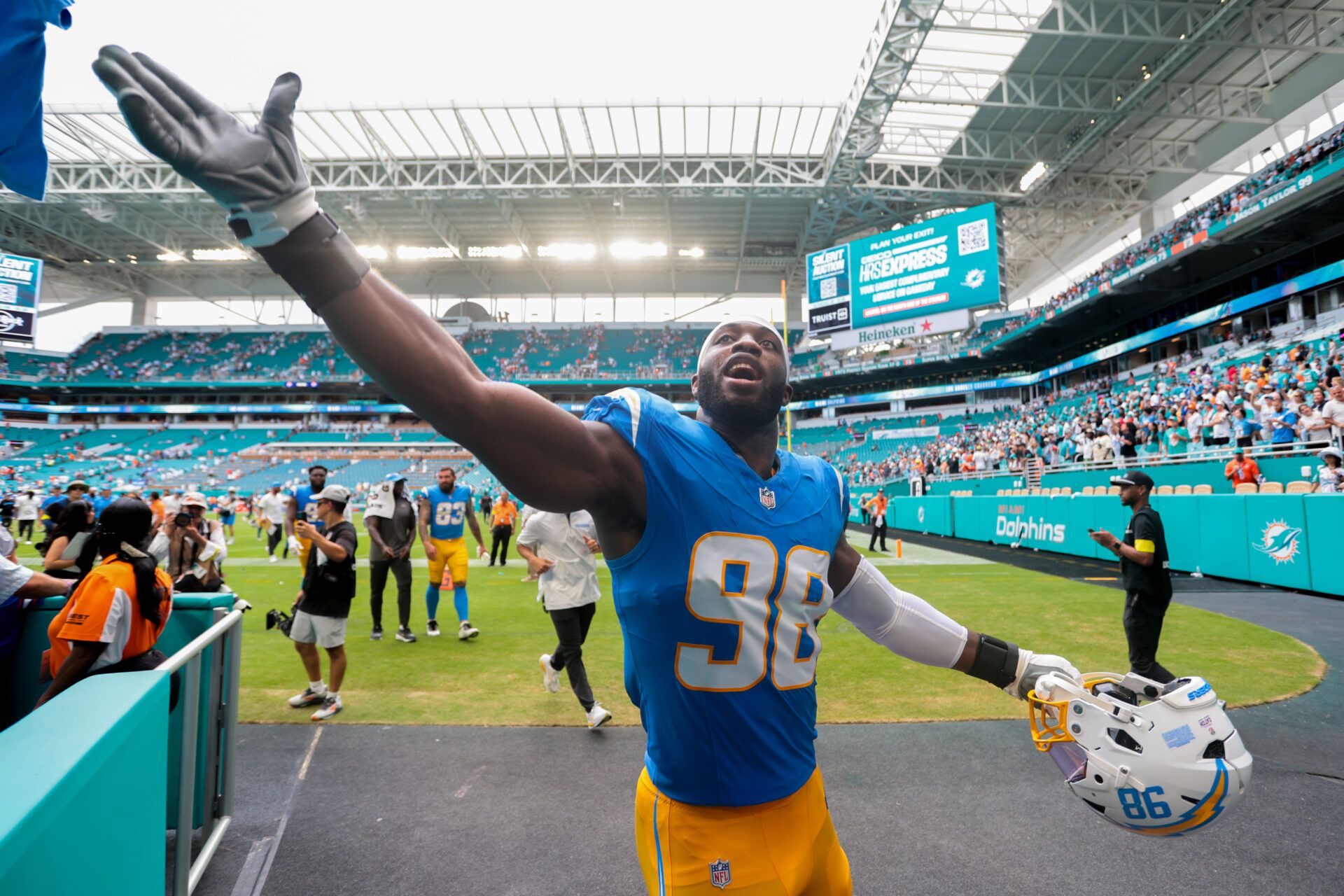 Los Angeles Chargers linebacker Odafe Oweh (98) celebrates with fans after the game against the Miami Dolphins at Hard Rock Stadium.