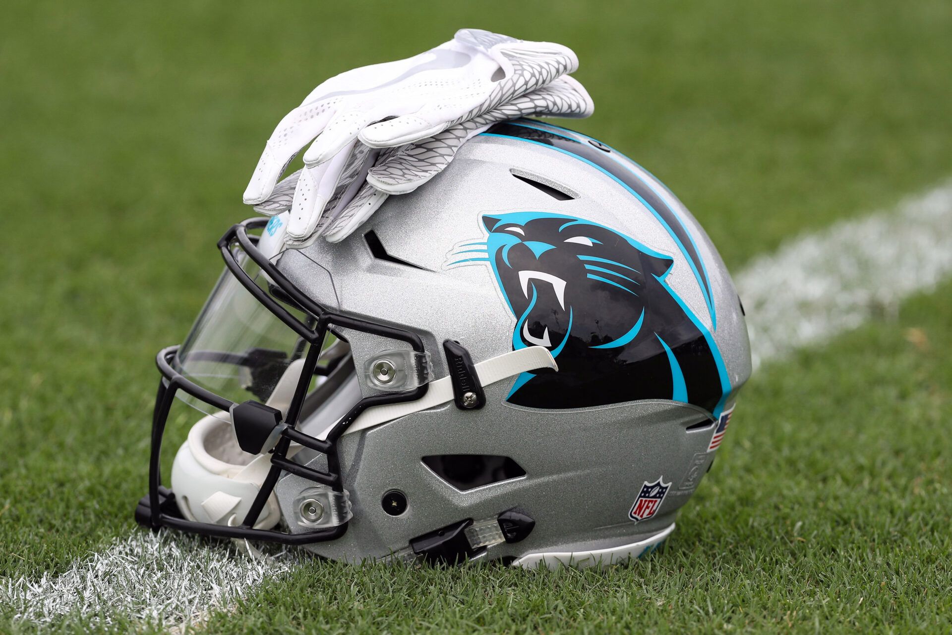 Carolina Panthers logo helmet and gloves wait on the turf during Panthers Training Camp at Wofford College.