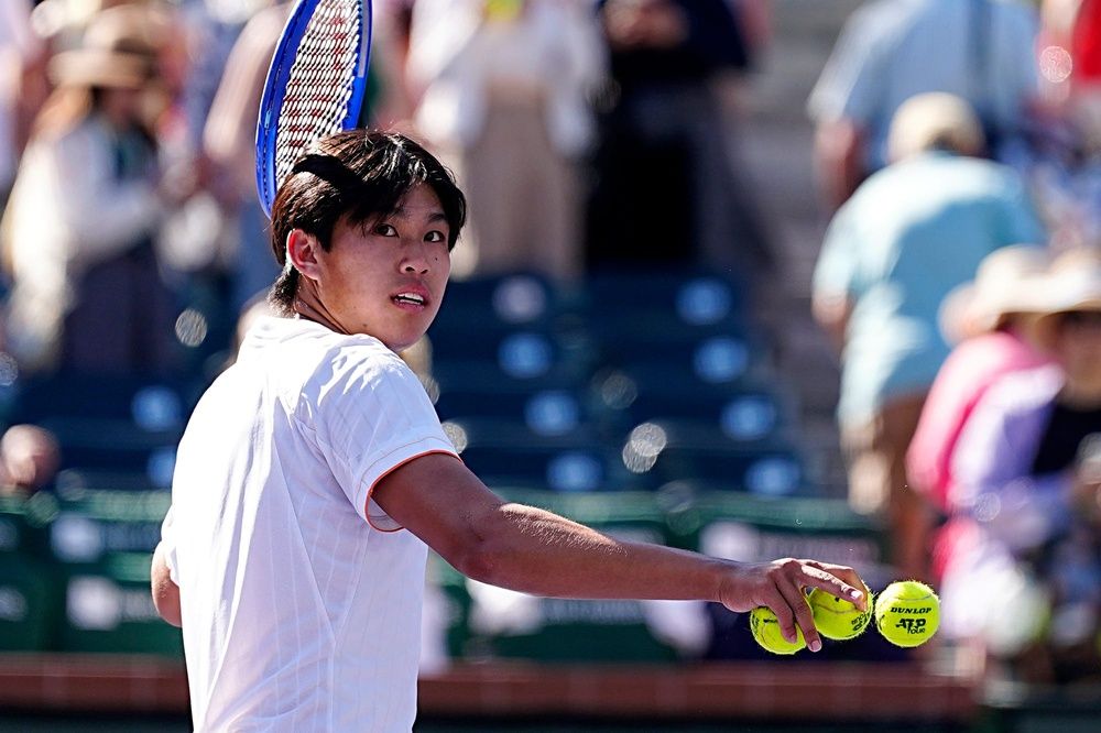 Learner Tien prepares to hit tennis balls to fans after defeating Ben Shelton on Stadium 1 during their BNP Paribas Open third-round match in Indian Wells, Calif., on March 8, 2026.