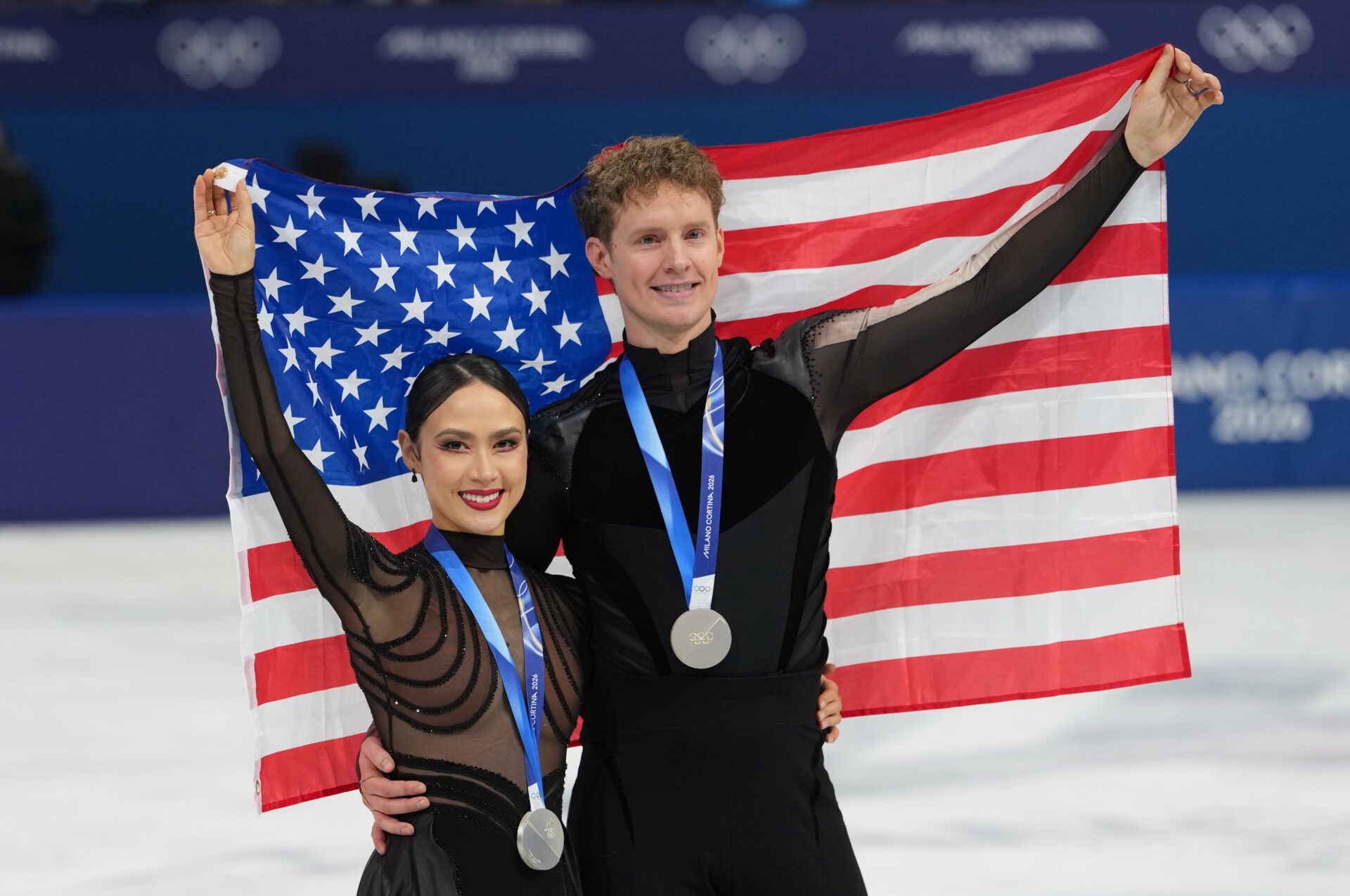 iFeb 11, 2026; Milan, Italy; Madison Chock and Evan Bates of the United States skate after receiving silver medals during the Milano Cortina 2026 Olympic Winter Games at Milano Ice Skating Arena.