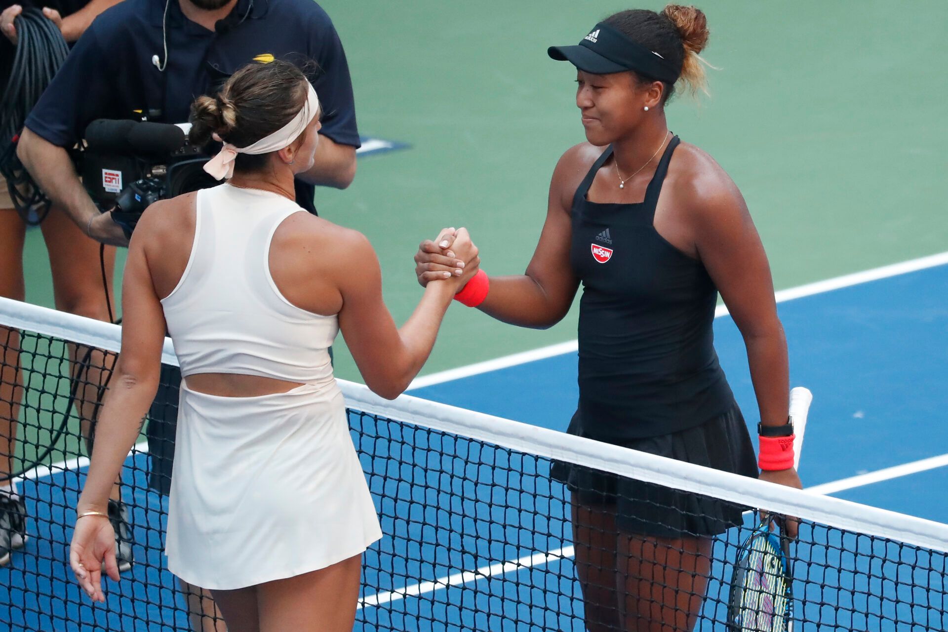Naomi Osaka of Japan (R) shakes hands with Aryna Sabalenka of Belarus (L) after their match in the fourth round on day eight of the US Open at USTA Billie Jean King National Tennis Center.