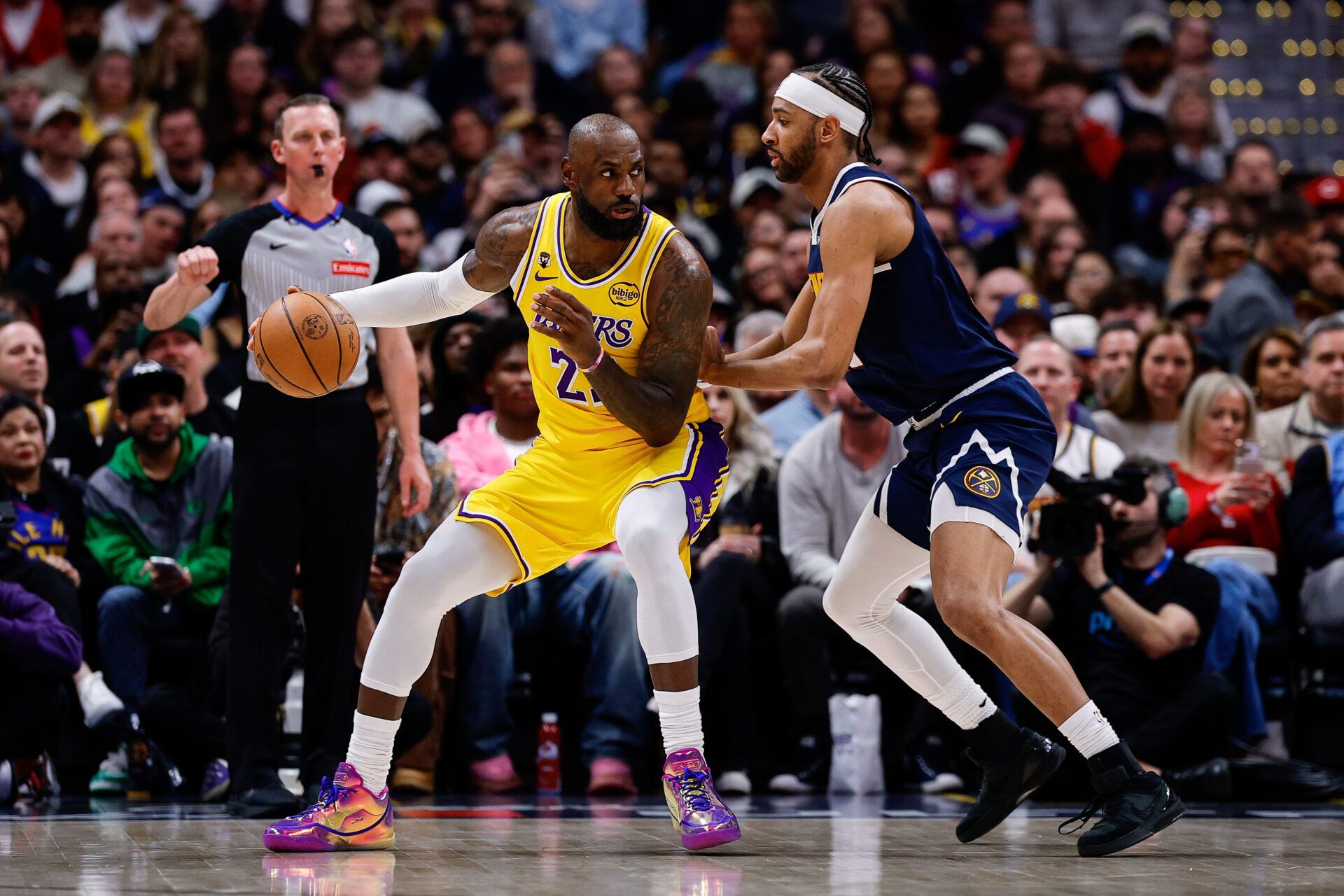 Los Angeles Lakers forward LeBron James (23) controls the ball against Denver Nuggets forward Zeke Nnaji (22) in the first quarter at Ball Arena.