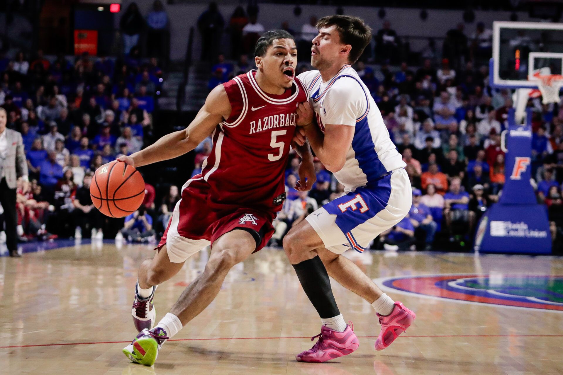 Arkansas Razorbacks guard Darius Acuff Jr. (5) drives the ball against Florida Gators guard Urban Klavzar (7) during the first half at Exactech Arena at the Stephen C. O'Connell Center.