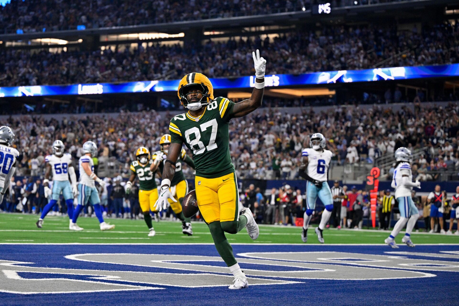 Green Bay Packers wide receiver Romeo Doubs (87) celebrates in the end zone after he catches a pass for a touchdown during the game between the Dallas Cowboys and the Green Bay Packers at AT&T Stadium.