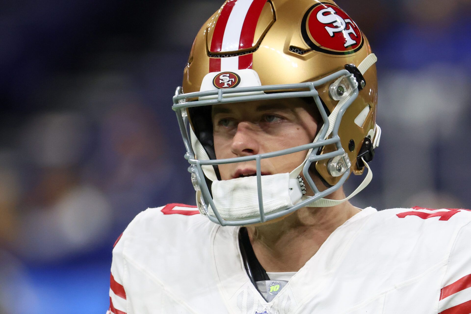 San Francisco 49ers quarterback Mac Jones (10) looks on during warmups before the game against the Indianapolis Colts at Lucas Oil Stadium.