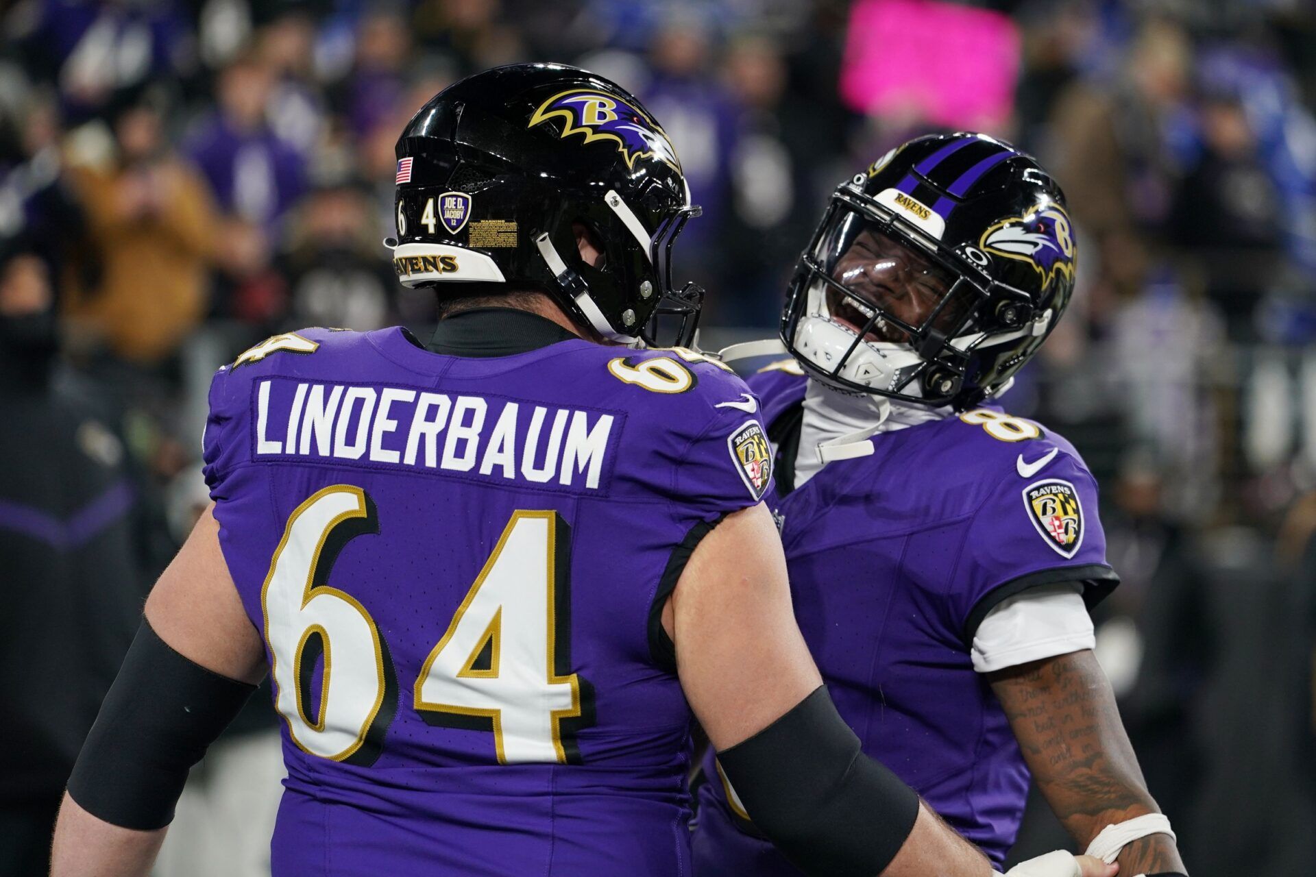 Baltimore Ravens quarterback Lamar Jackson (8) and center Tyler Linderbaum (64) warm up before an AFC wild card game against the Pittsburgh Steelers at M&T Bank Stadium.
